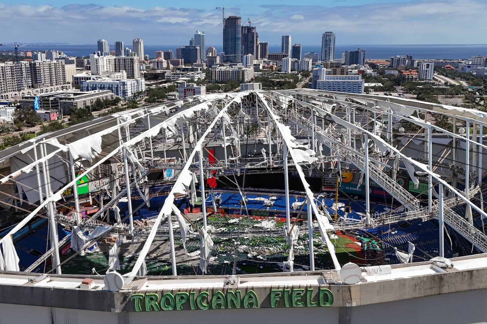 FILE - The roof of the Tropicana Field is damaged the morning after Hurricane Milton hit the region, Thursday, Oct. 10, 2024, in St. Petersburg, Fla. (AP Photo/Mike Carlson, File)