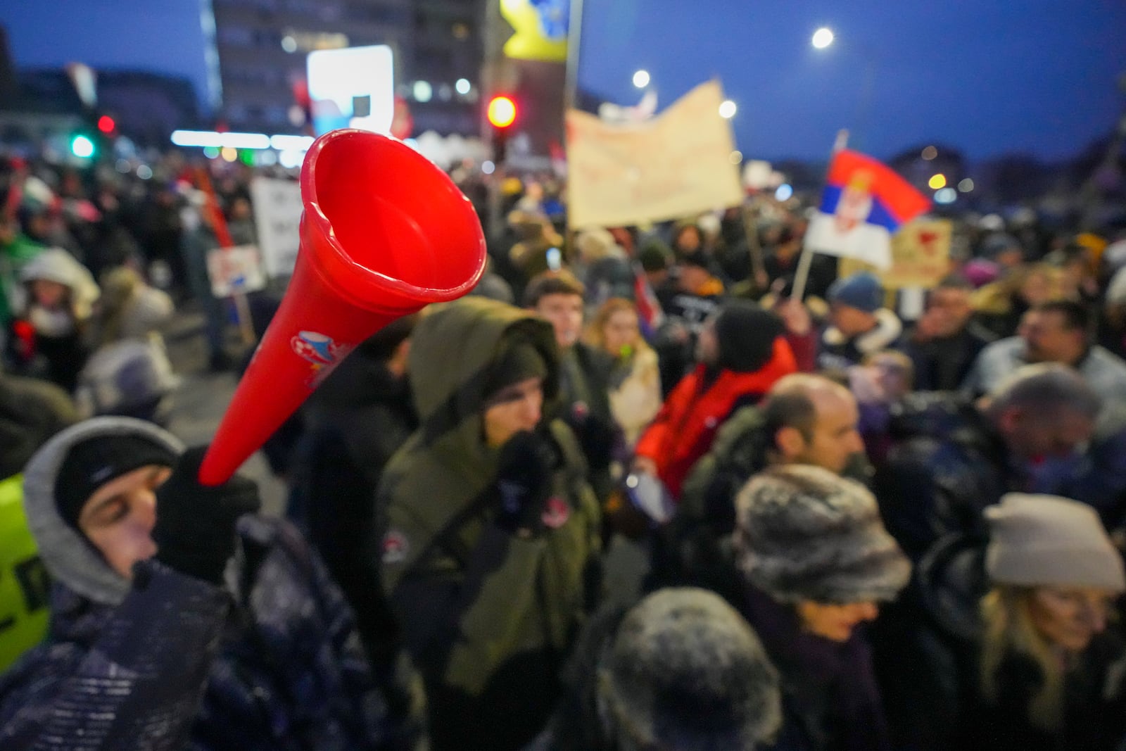 A man blows a vuvuzela during a student-led large protest and a 15-hour blockade of the streets in Serbian industrial town of Kragujevac, to protest the deaths of 15 people killed in the November collapse of a train station canopy, Saturday, Feb. 15, 2025. (AP Photo/Darko Vojinovic)