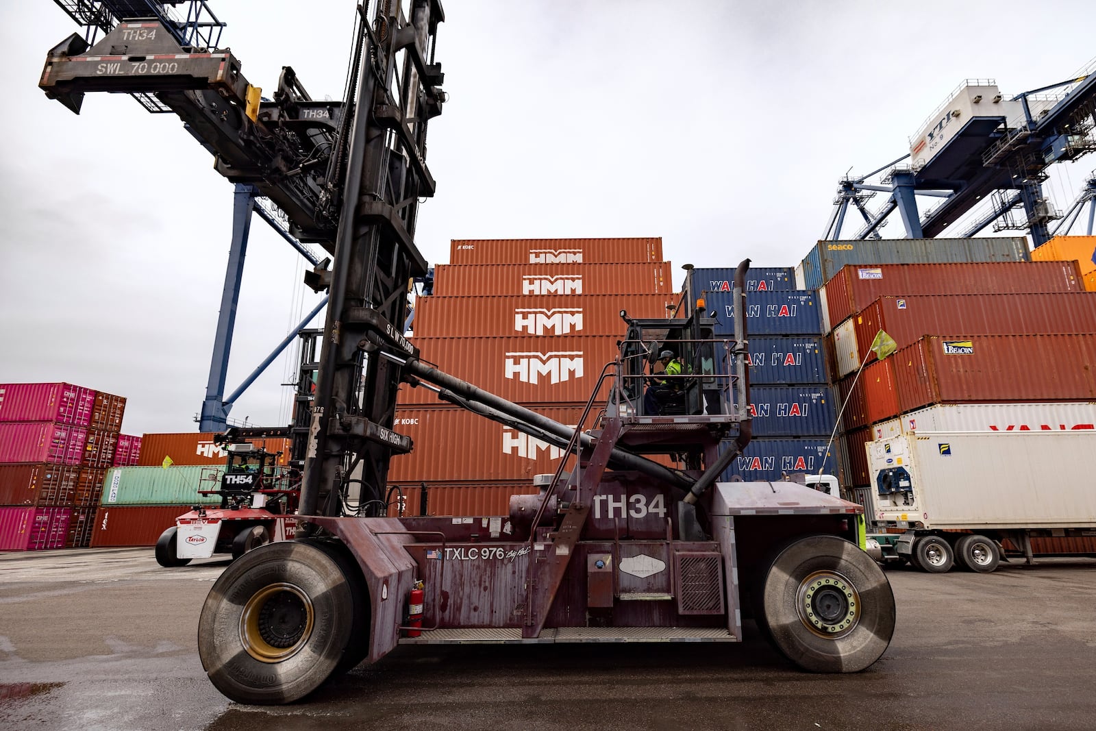 A top-handler drives in the Yusen Terminal at the Port of Los Angeles, Tuesday, March 11, 2025, in San Pedro, Calif. (AP Photo/Etienne Laurent)