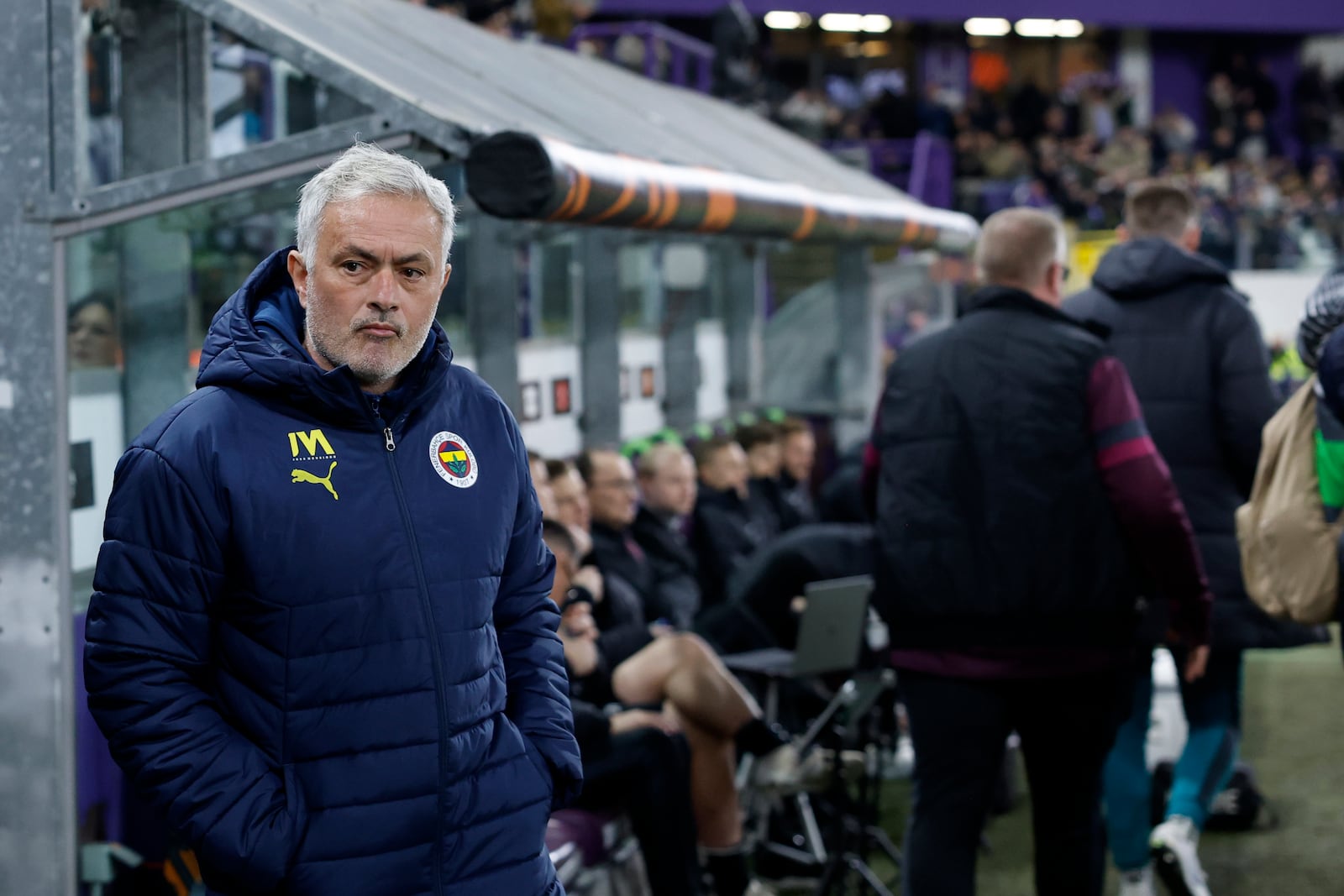 Fenerbahce's head coach Jose Mourinho, left, during the Europa League playoff second leg soccer match between Anderlecht and Fenerbahce at the RSC Anderlecht stadium in Brussels, Thursday, Feb. 20, 2025. (AP Photo/Omar Havana)