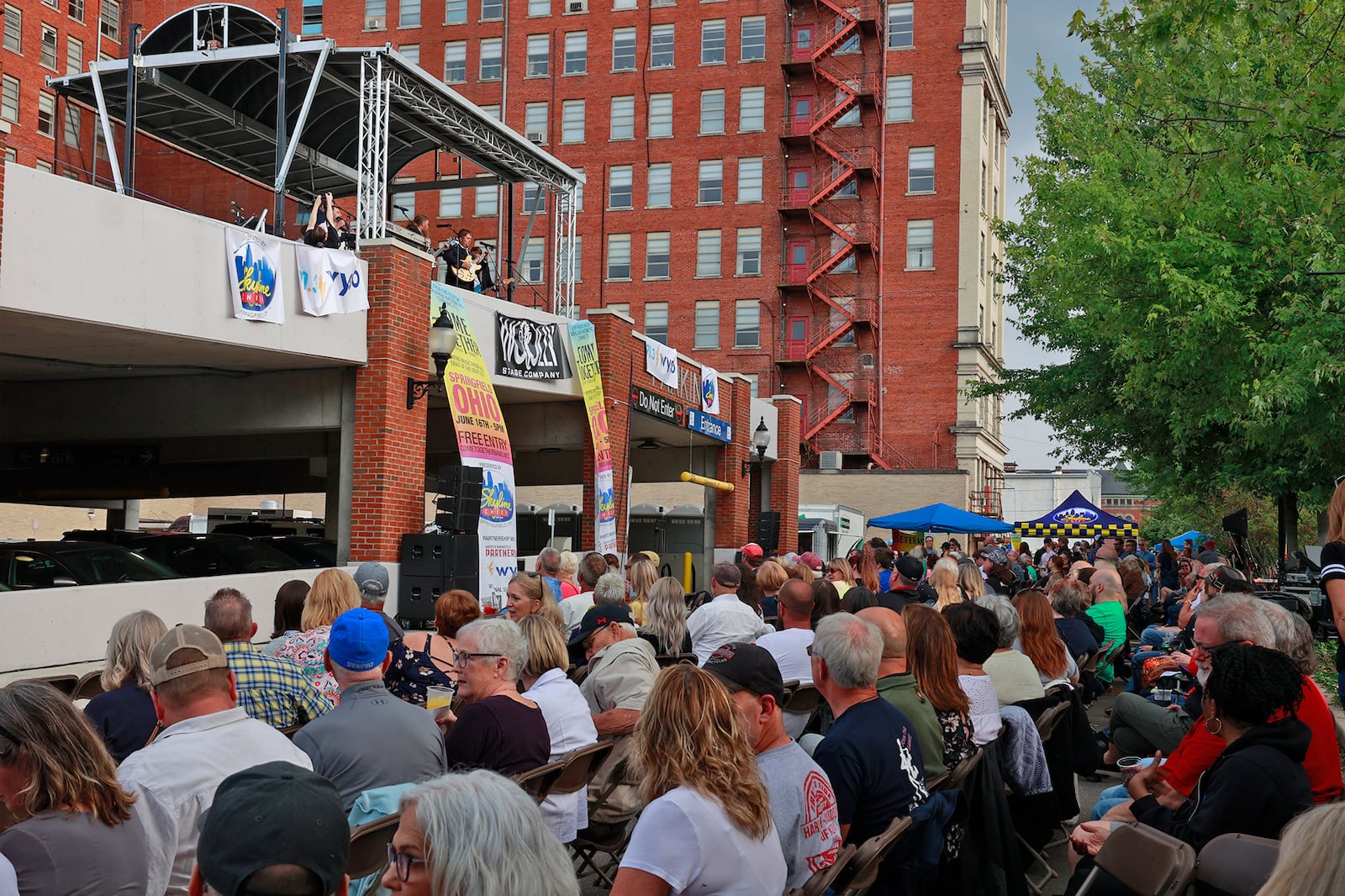 Hundreds of people gathered in National Road Commons Park in downtown Springfield for the Come Together Springfield 2023 - A Rooftop Beatles Tribute Friday, June 16, 2023. The Beatles tribute band played from the top of the city parking garage over looking the sea of music lovers that covered the park in their lawn chairs and blankets. The event, sponsored by Skyline Chili in conjuction with the Greater Springfield Partnership, also featured a variety of food trucks and refreshments. BILL LACKEY/STAFF