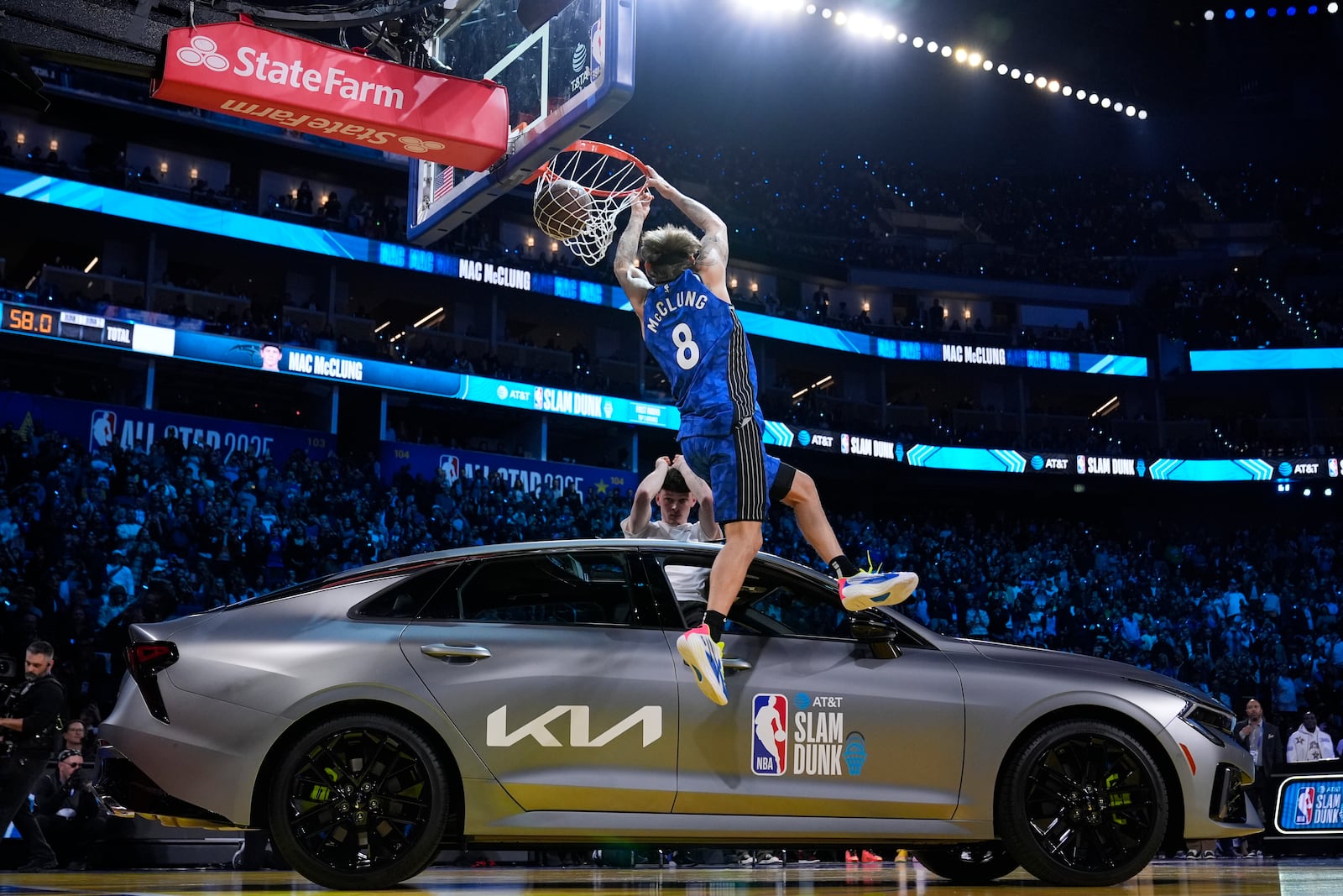 Orlando Magic guard Mac McClung dunks over a car during the slam dunk contest at the NBA basketball All-Star Saturday night festivities Saturday, Feb. 15, 2025, in San Francisco. (AP Photo/Godofredo A. Vásquez)