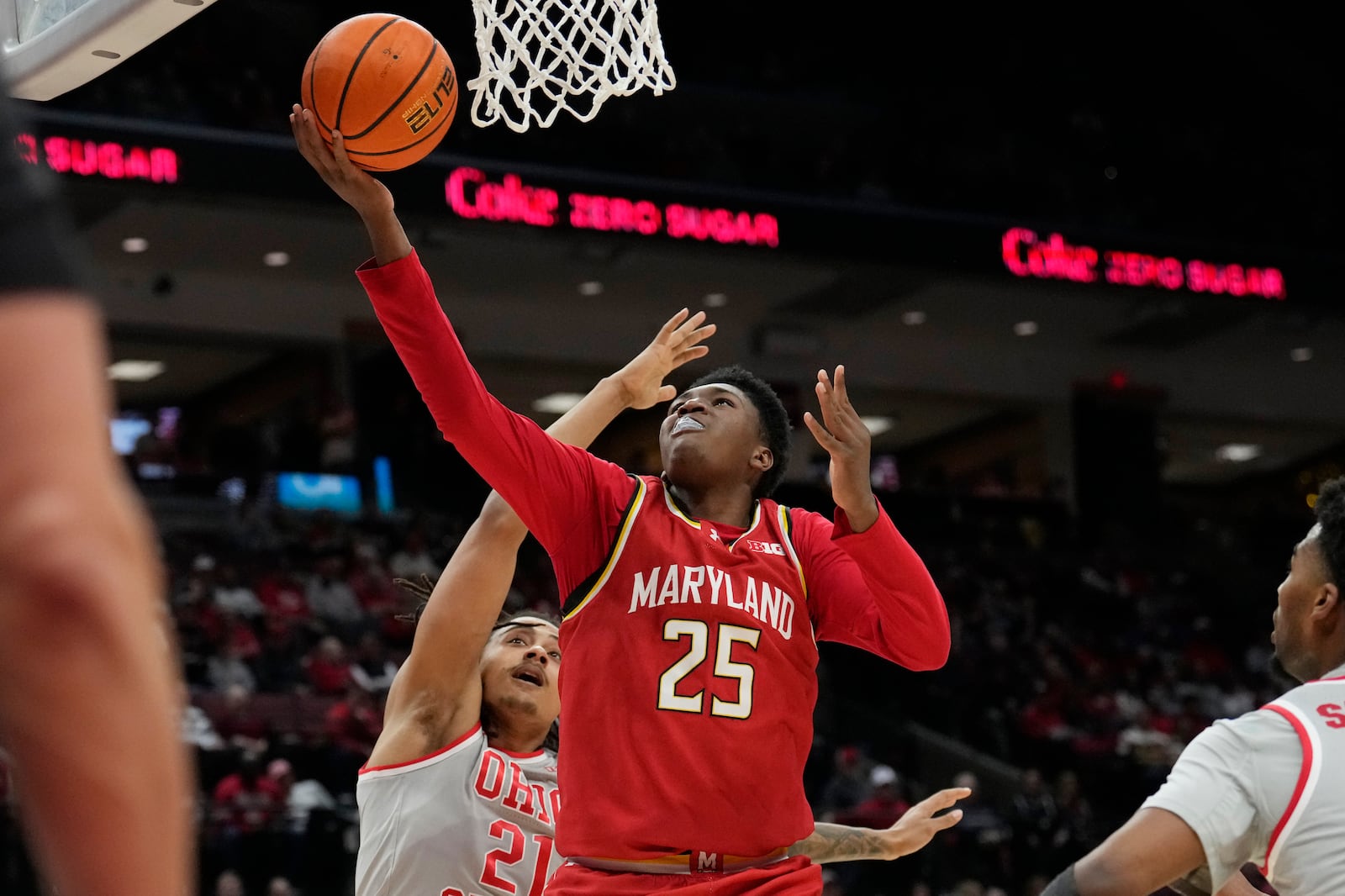 Maryland center Derik Queen (25) shoots in front of Ohio State forward Devin Royal (21) in the first half of an NCAA college basketball game Thursday, Feb. 6, 2025, in Columbus, Ohio. (AP Photo/Sue Ogrocki)