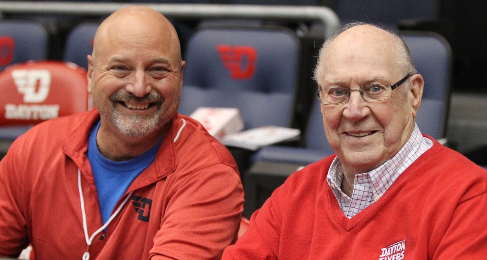 WHIO’S Larry Hansgen and Bucky Bockhorn pose for a photo before Dayton’s game against North Florida on Wednesday, Nov. 7, 2018, at UD Arena. David Jablonski/Staff