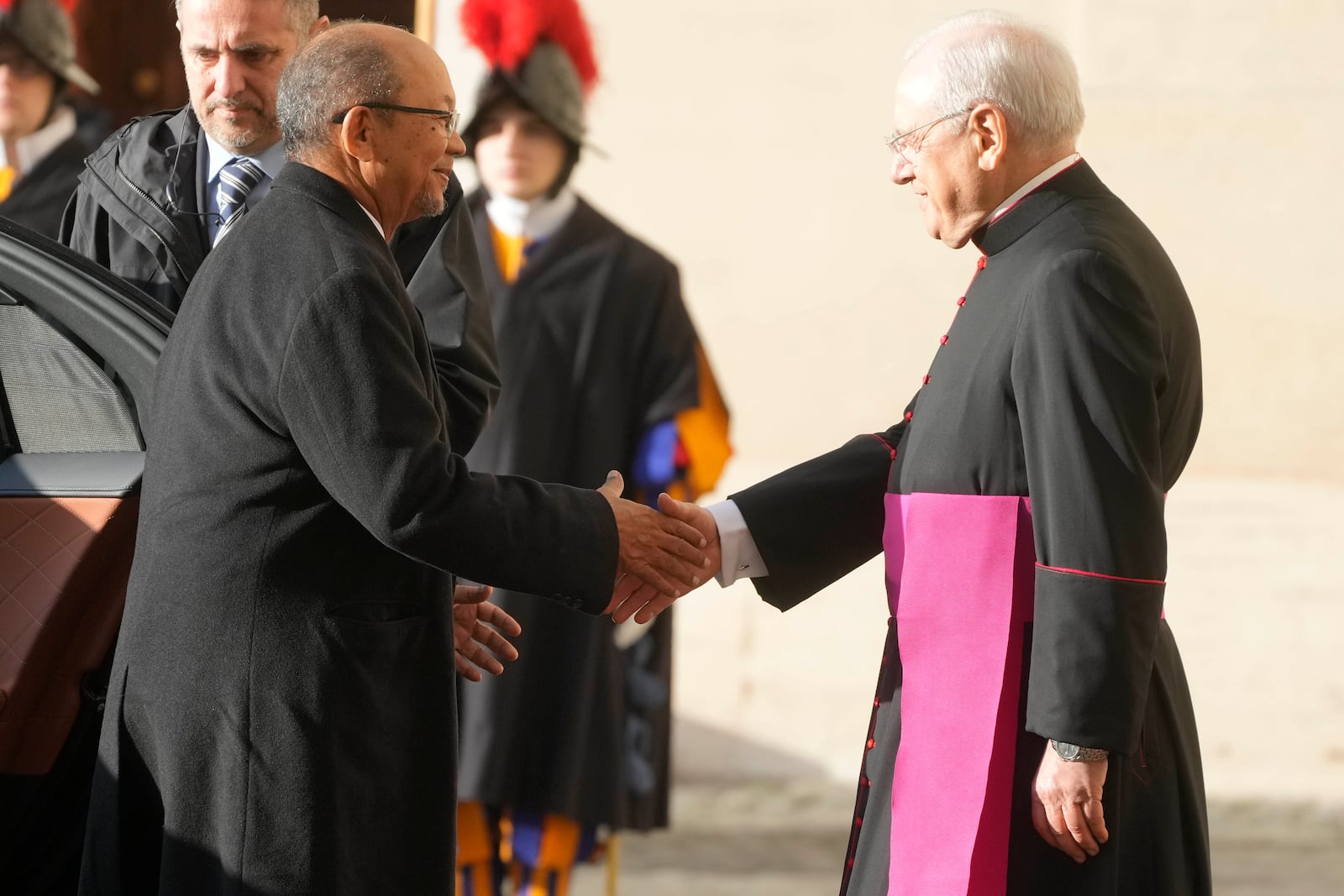 Haiti's President Leslie Voltaire, left, is welcomed by Father Leonardo Sapienza ahead of his meeting with Pope Francis at the Vatican, Saturday, Jan. 25, 2025. (AP Photo/Gregorio Borgia)