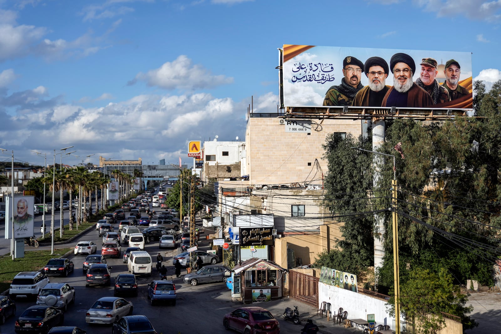 People drive past a billboard with pictures of the late Lebanon's Hezbollah leader Sayyed Hassan Nasrallah, center, late Lebanon's Hezbollah leader Sayyed Hashem Safieddine, second left, Hezbollah top commander Fouad Shukur, left, Hezbollah senior commander Ali Karaki, second right, and Hezbollah commander Ibrahim Akil, right, displayed on Beirut airport highway, Lebanon, Friday, Feb. 21, 2025. (AP Photo/Bilal Hussein)