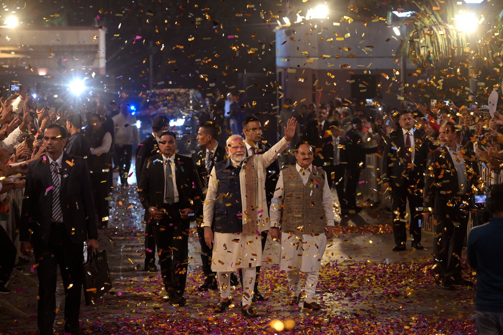 Bharatiya Janata Party supporters shower confetti and flower petals as Indian prime minister Narendra Modi, center, arrives to address them at the party headquarters after wining the state elections in politically significant Indian state of Maharashtra, in New Delhi, India, Saturday, Nov. 23, 2024. (AP Photo)