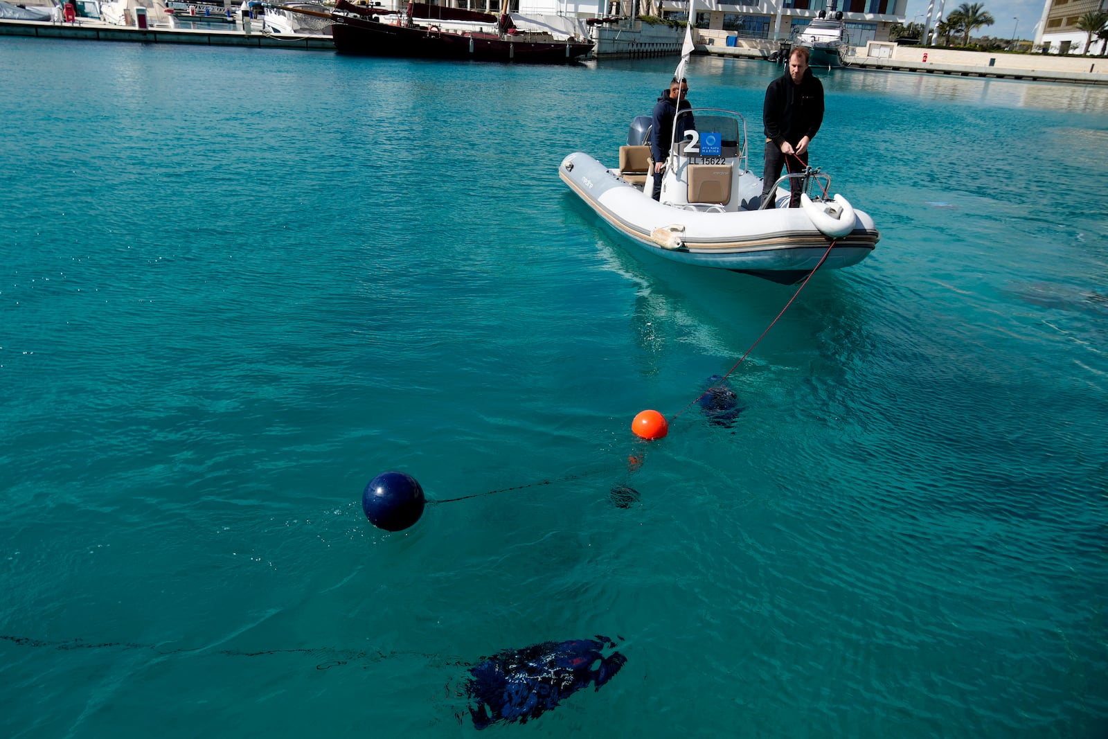 Underwater drones are seen inside the seawater next of an assist boat with two personnel, during a demonstration at a Marina in southern resort of Ayia Napa, Cyprus, Monday, February. 24, 2025. (AP Photo/Petros Karadjias)