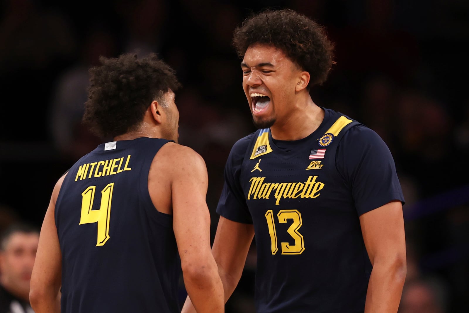 Marquette forward Royce Parham (13) reacts with Stevie Mitchell (4) after dunking the ball during the first half of an NCAA college basketball game against Xavier in the quarterfinals of the Big East Conference tournament, Thursday, March 13, 2025, in New York. (AP Photo/Pamela Smith)