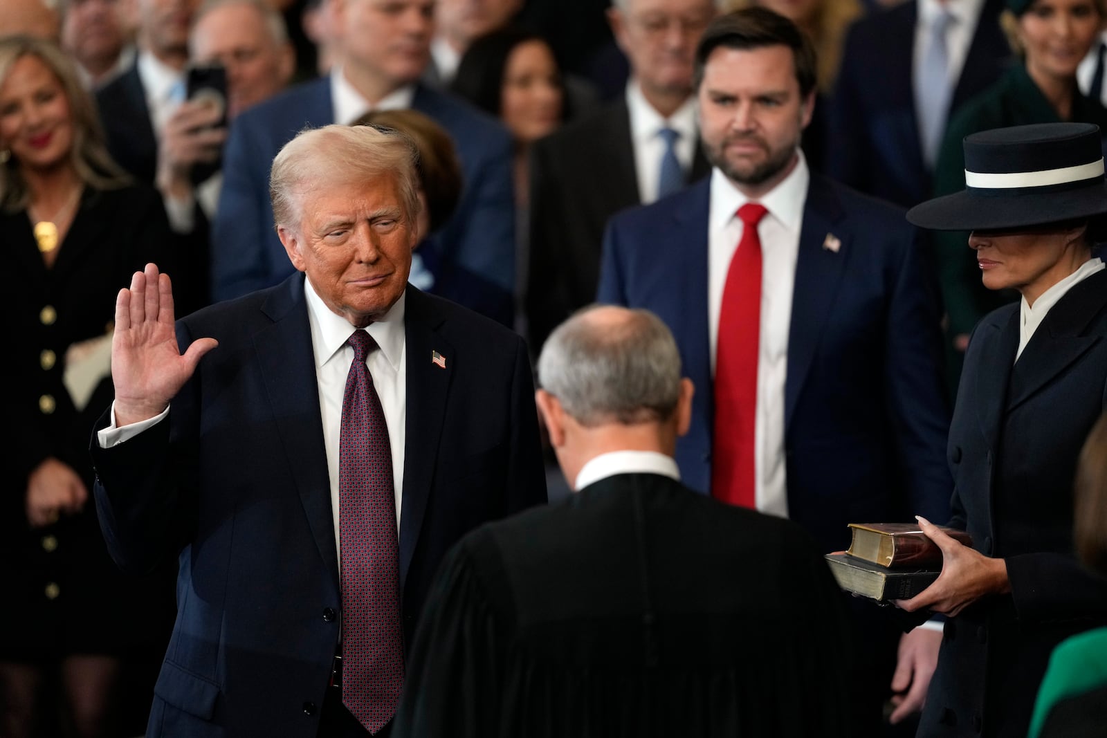 Donald Trump is sworn in as the 47th president of the United States by Chief Justice John Roberts as Melania Trump holds the Bible during the 60th Presidential Inauguration in the Rotunda of the U.S. Capitol in Washington, Monday, Jan. 20, 2025. (AP Photo/Julia Demaree Nikhinson, Pool)