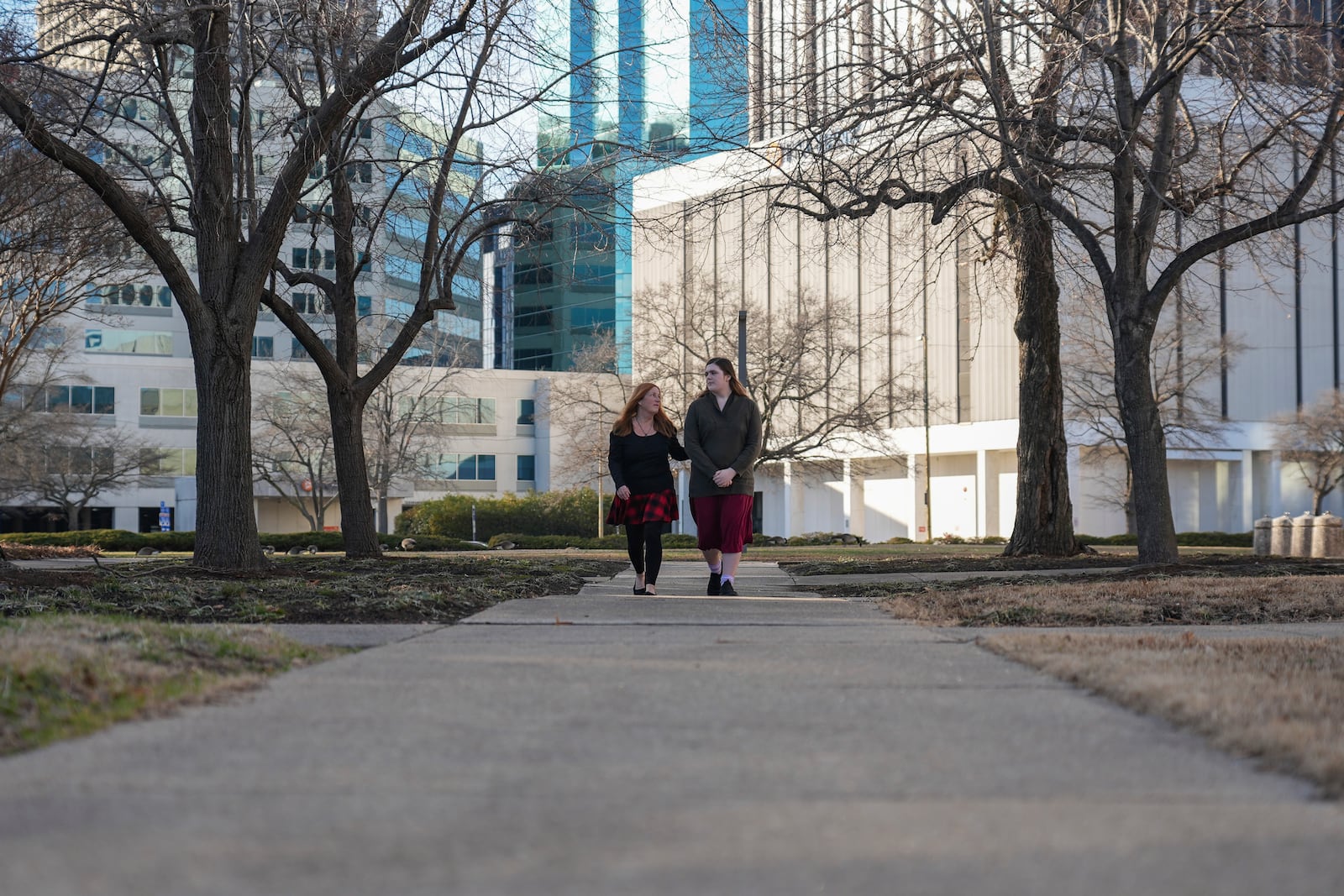 Lisa Suhay, left, walks with her daughter Mellow, who is transgender, Monday, Feb. 3, 2025, in Norfolk, Va. (AP Photo/Stephanie Scarbrough)