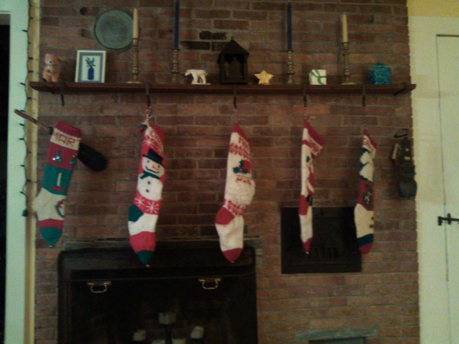 Christmas stockings knitted by Martha Tecca’s mother hang in 2014 by the original 1790s fireplace in their Lyme, N.H., house, which burned down in a 2015 fire. (Tecca family via AP)