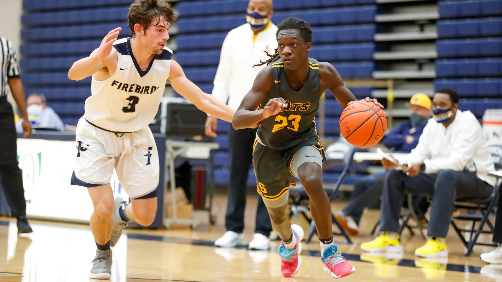 Springfield High School guard Micha Johnson drives past Fairmont's Ryan Soter during their game on Tuesday night at Trent Arena. Johnson scored 14 points as the Wildcats won 46-44. Michael Cooper/CONTRIBUTED