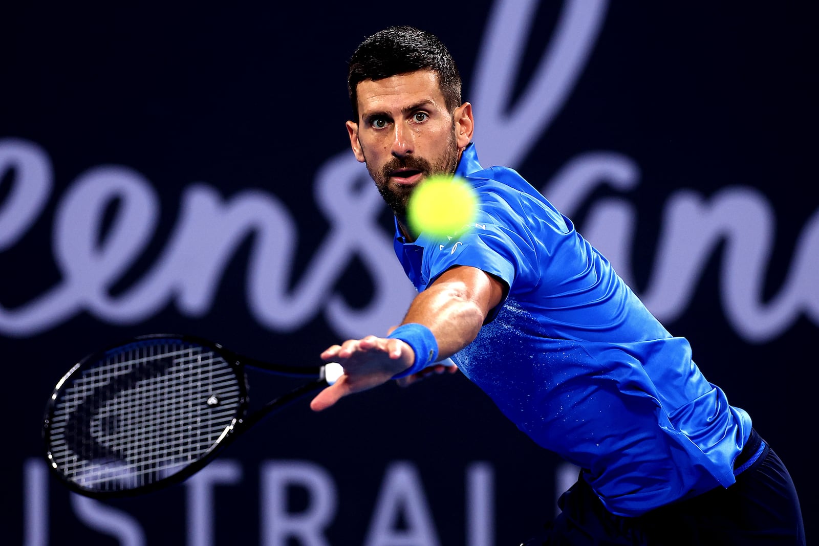 Serbia's Novak Djokovic plays a forehand against USA's Reilly Opelka during their match at the Brisbane International, in Brisbane, Australia, Friday, Jan. 3, 2025. (AP Photo/Pat Hoelscher)