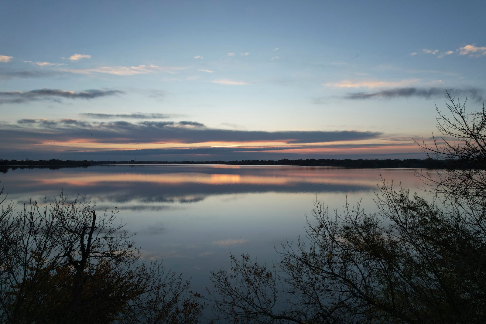 The sun rises over the Okabena Lake in Worthington, Minn., on Tuesday Oct. 22, 2024. (AP Photo/Jessie Wardarski)