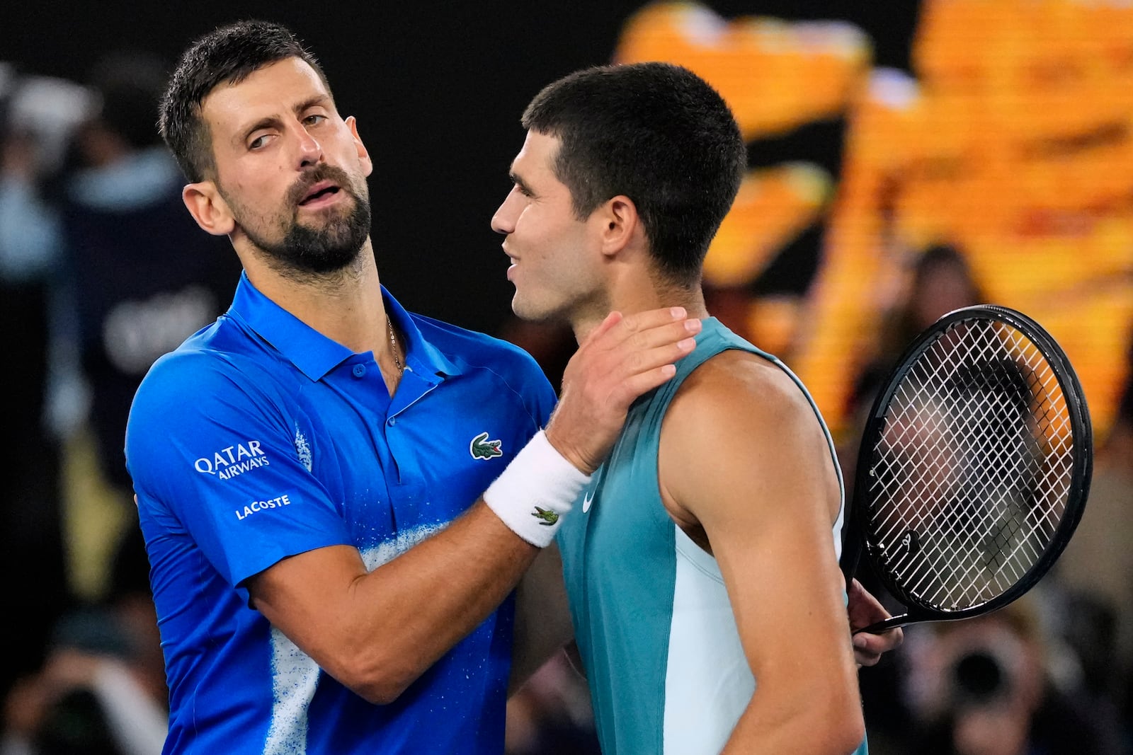 Novak Djokovic, left, of Serbia, is congratulated by Carlos Alcaraz of Spain following their quarterfinal match at the Australian Open tennis championship in Melbourne, Australia, Wednesday, Jan. 22, 2025. (AP Photo/Vincent Thian)