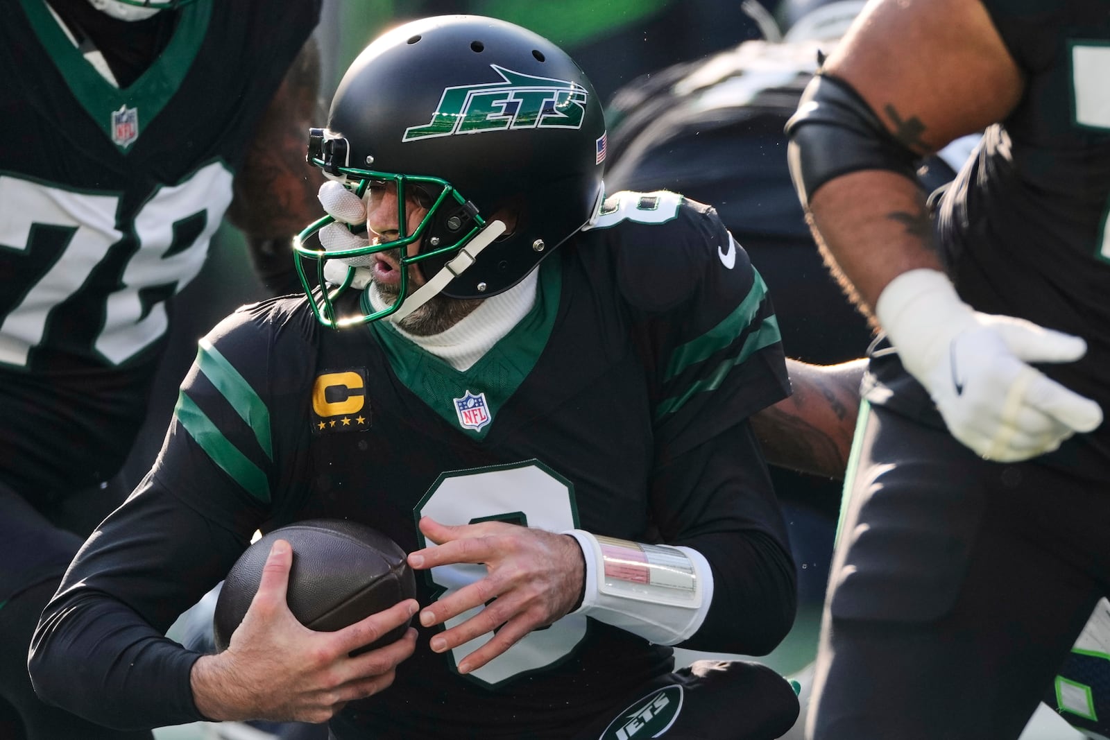 New York Jets quarterback Aaron Rodgers (8) is pulled down by his face mask during the first quarter of an NFL football game against the Seattle Seahawks, Sunday, Dec. 1, 2024, in East Rutherford, N.J. (AP Photo/Seth Wenig)