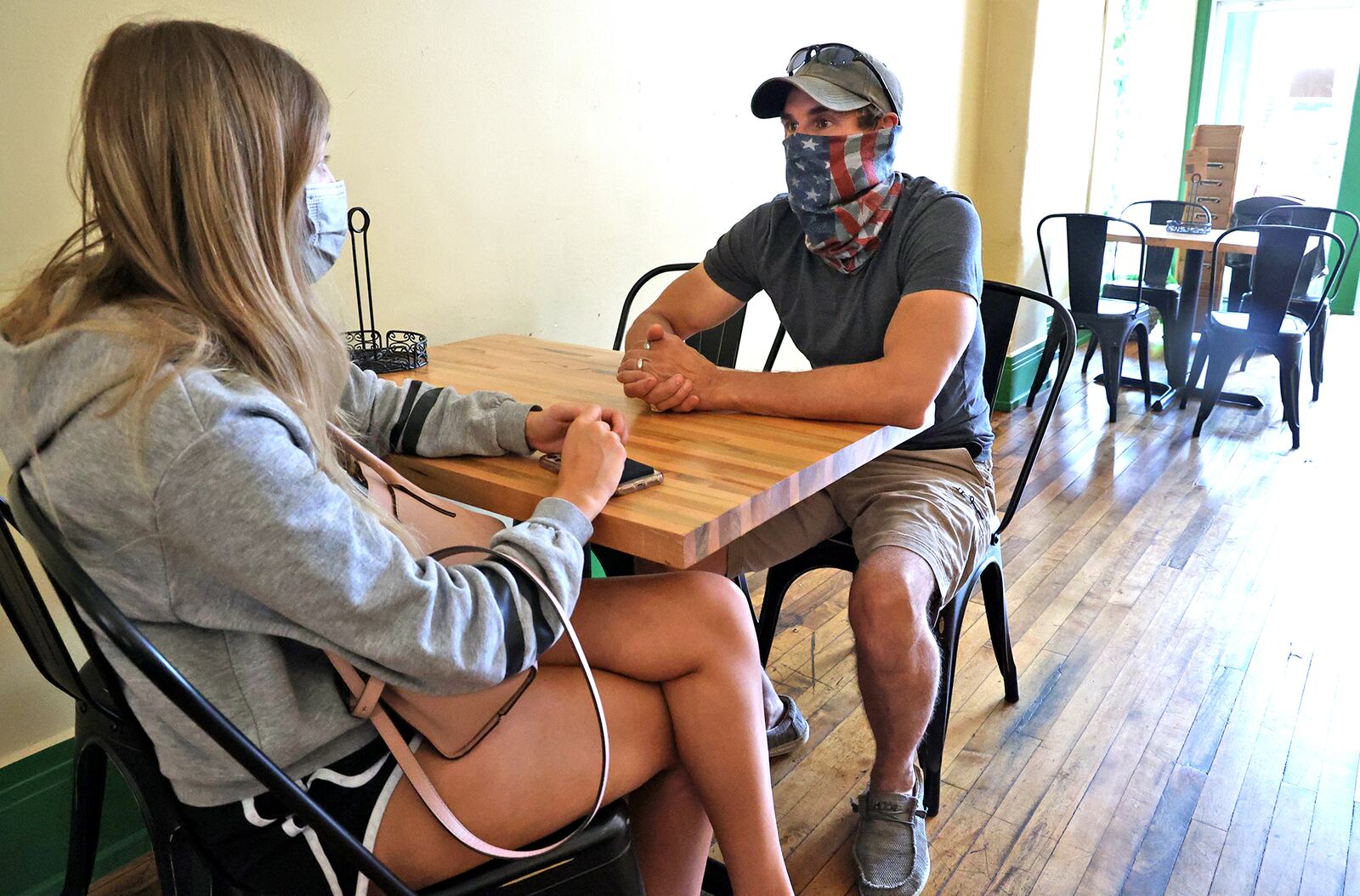 Madalynn and David Garrett wear their masks Tuesday as they wait for their food at Salato Deli in downtown Springfield. Both said they are looking forward to the mask mandate being lifted. BILL LACKEY/STAFF