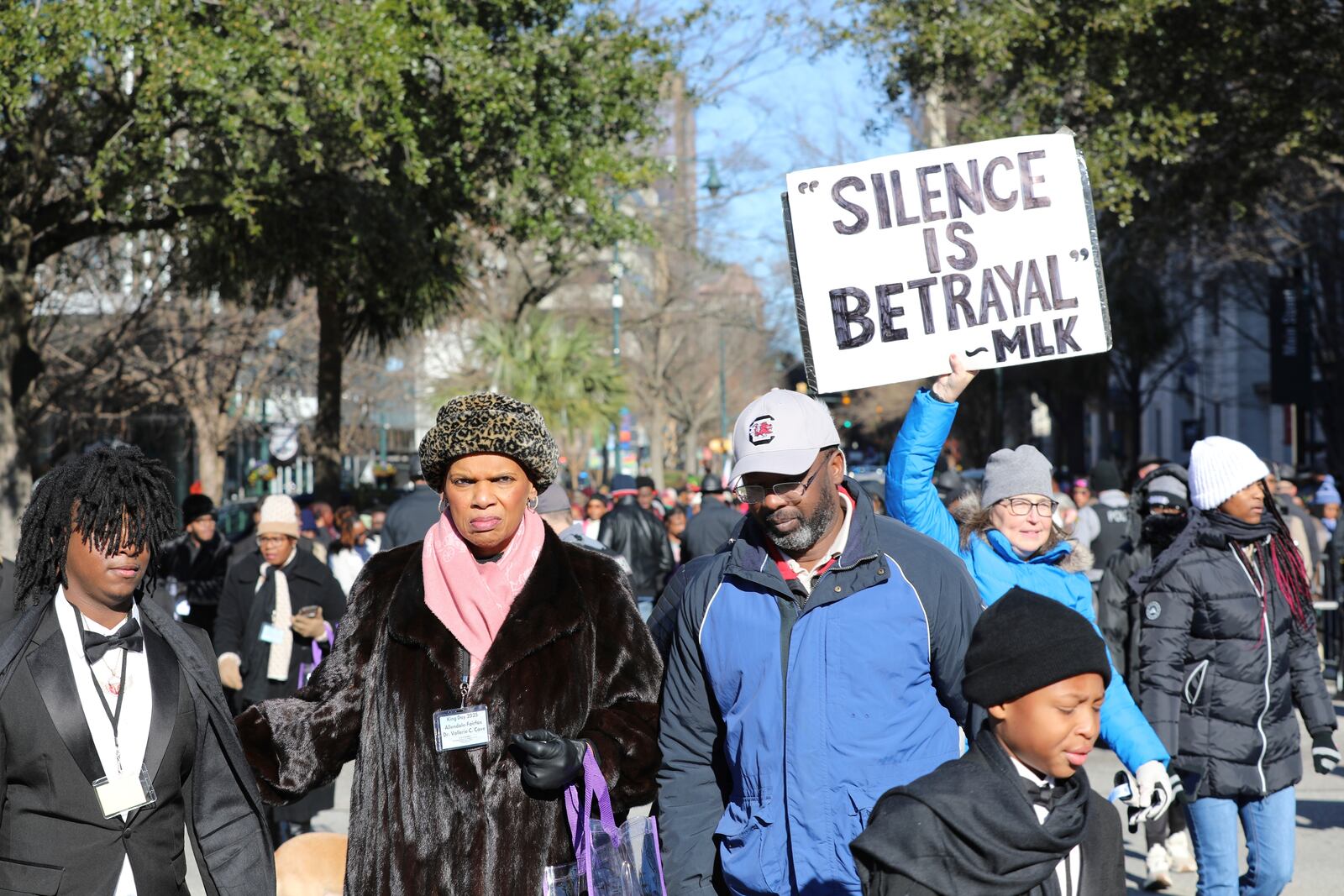 A marcher holds up a sign at a march and rally at the South Carolina Statehouse to honor Martin Luther King Jr. on his holiday on Monday, Jan. 20, 2025, in Columbia, S.C. (AP Photo/Jeffrey Collins)