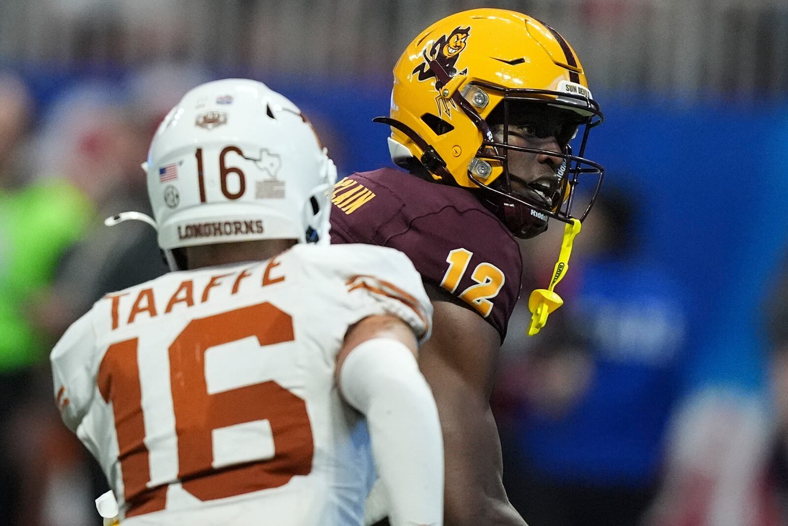 Arizona State wide receiver Malik McClain (12) runs into the end zone for a touchdown against Texas defensive back Michael Taaffe (16) during the second half in the quarterfinals of a College Football Playoff game, Wednesday, Jan. 1, 2025, in Atlanta. (AP Photo/Brynn Anderson)