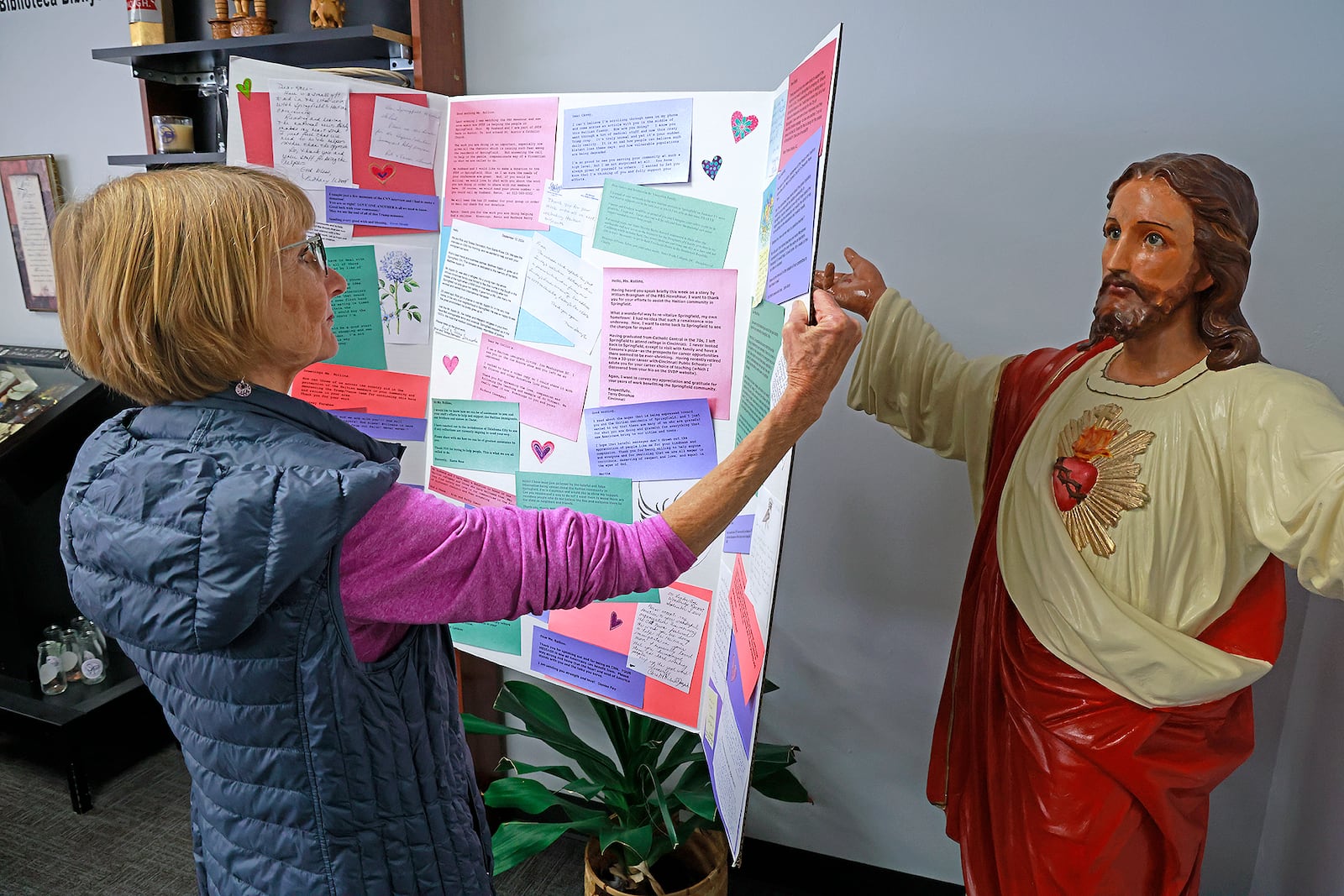 Connie Kearns looks over some of the letters of support St. Vincent DePaul in Springfield has received from people around the world Tuesday, Nov. 12, 2024. BILL LACKEY/STAFF