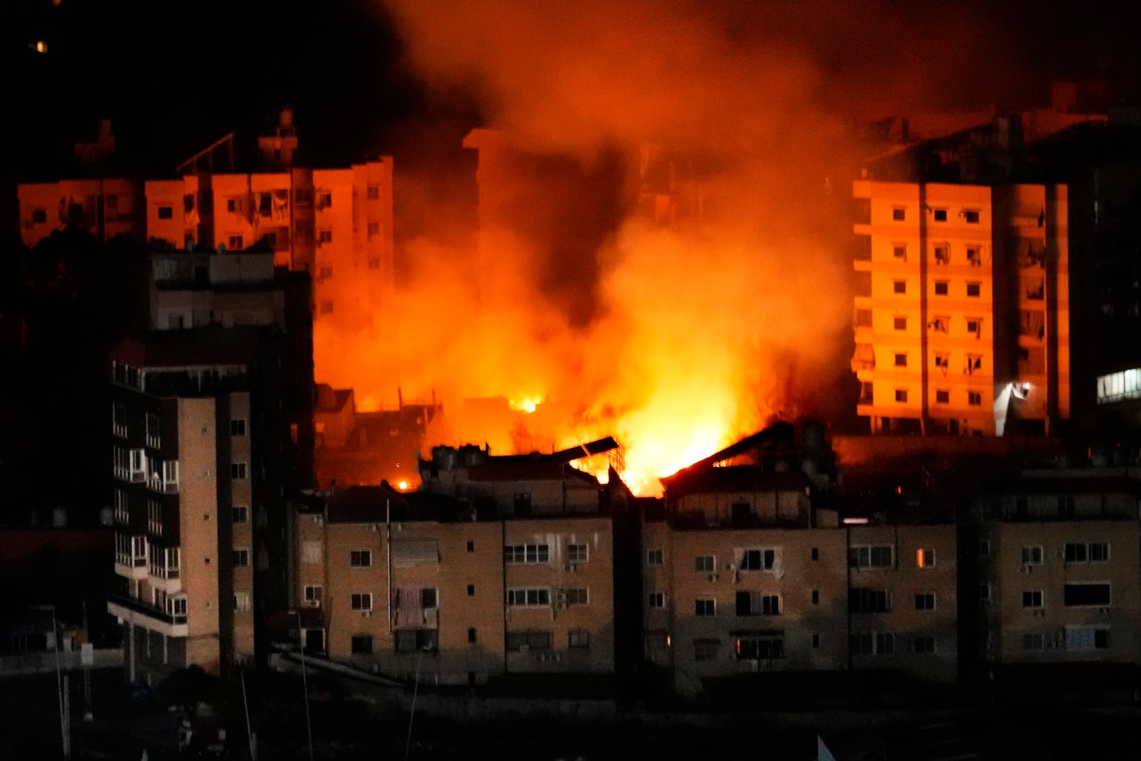 Flame and smoke rises from buildings hit by Israeli airstrikes on Dahiyeh, in the southern suburb of Beirut, Wednesday, Oct. 23, 2024. (AP Photo/Hussein Malla)