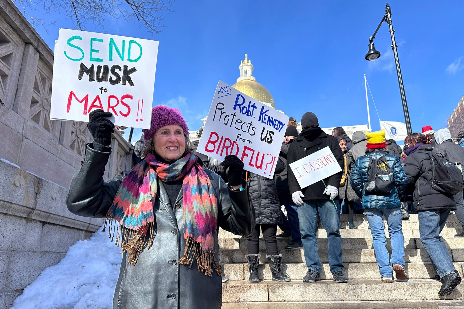 Demonstrators join more than a thousand people protesting the policies of the Trump administration marched from the Boston Common past City Hall to the North End, Monday, Feb. 17, 2025 in Boston. (AP/Michael Casey)