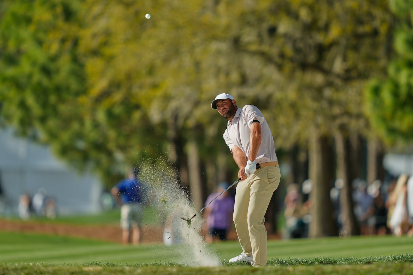 Scottie Scheffler hits his approach shot on the 16th hole during the third round of The Players Championship golf tournament Saturday, March 15, 2025, in Ponte Vedra Beach, Fla. (AP Photo/Julia Demaree Nikhinson)