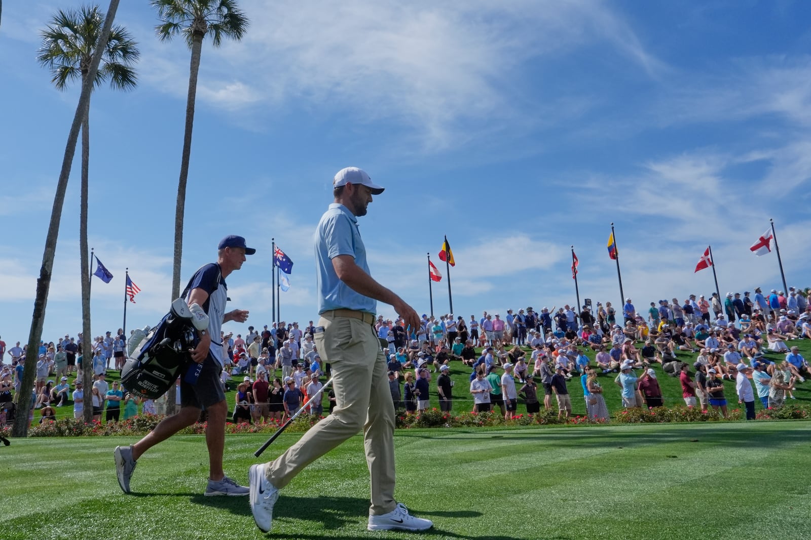 Scottie Scheffler walks off the third tee during the second round of The Players Championship golf tournament Friday, March 14, 2025, in Ponte Vedra Beach, Fla. (AP Photo/Julia Demaree Nikhinson)