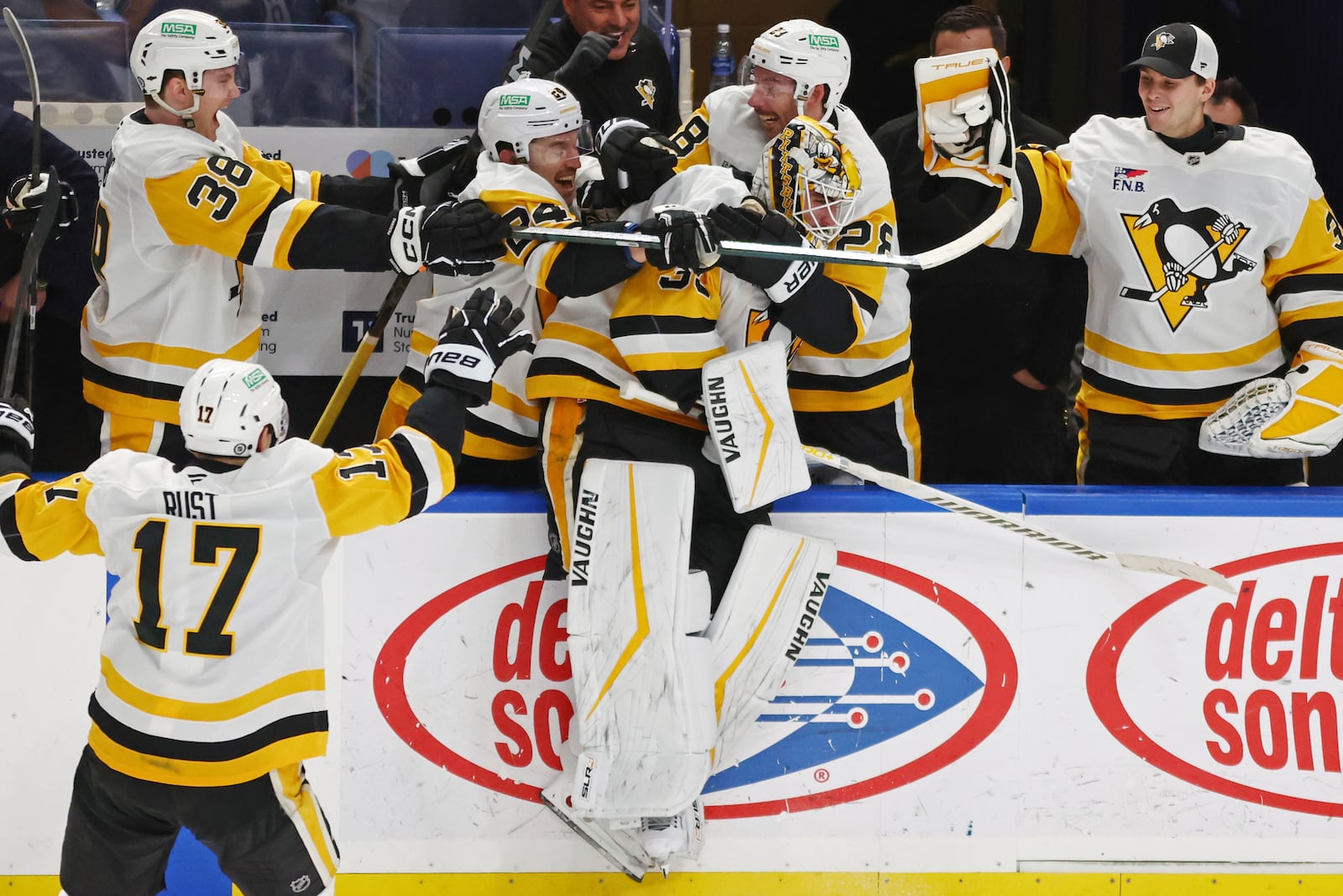 Pittsburgh Penguins goaltender Alex Nedeljkovic, center, celebrates with teammates after scoring during the third period of an NHL hockey game against the Buffalo Sabres, Friday, Jan. 17, 2025, in Buffalo, N.Y. (AP Photo/Jeffrey T. Barnes)