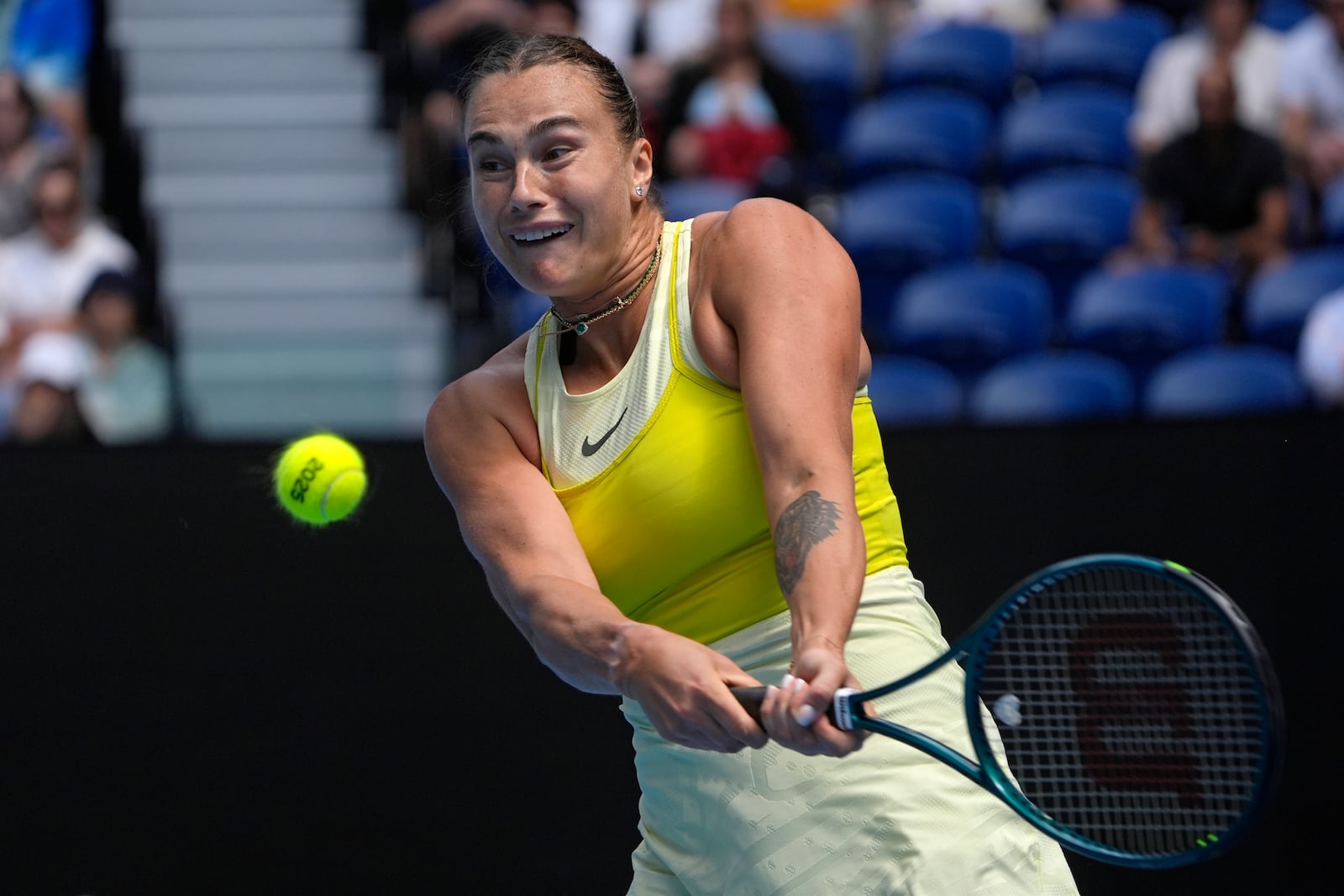 Aryna Sabalenka of Belarus plays a backhand return to Clara Tauson of Denmark during their third round match at the Australian Open tennis championship in Melbourne, Australia, Friday, Jan. 17, 2025. (AP Photo/Asanka Brendon Ratnayake)