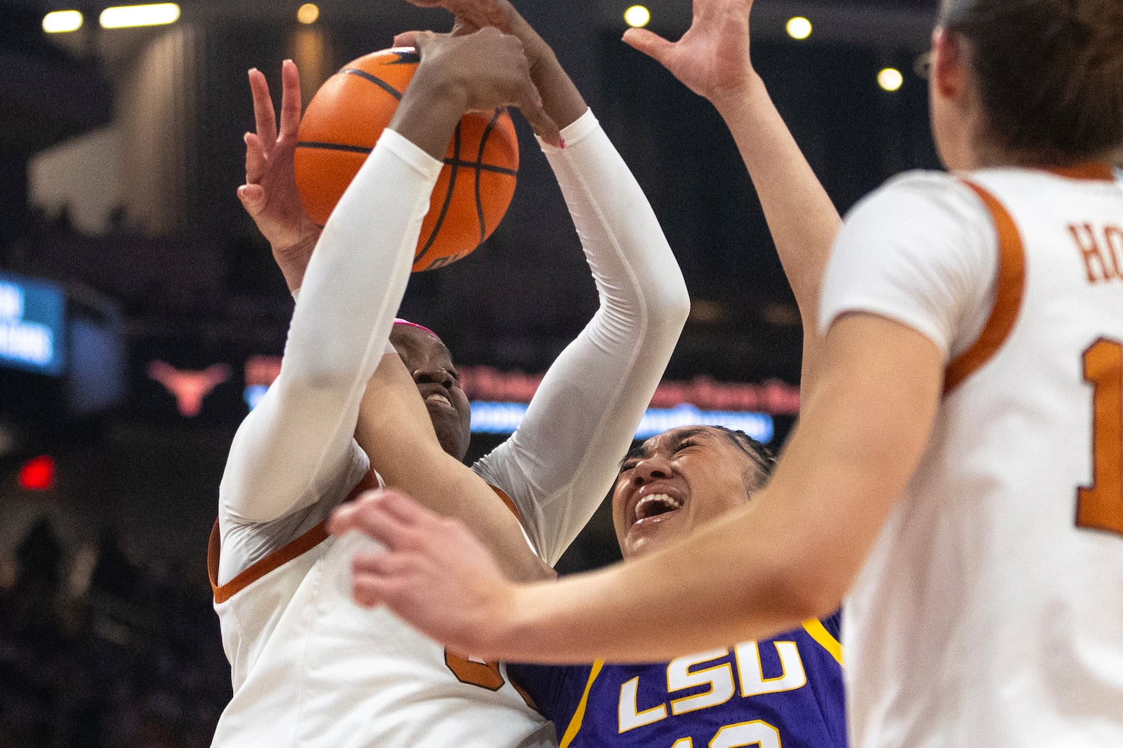 Texas forward Kyla Oldacre, left, defends LSU guard Last-Tear Poa (13) during the first half of an NCAA college basketball game in Austin, Texas, Sunday, Feb. 16, 2025. (AP Photo/Stephen Spillman)