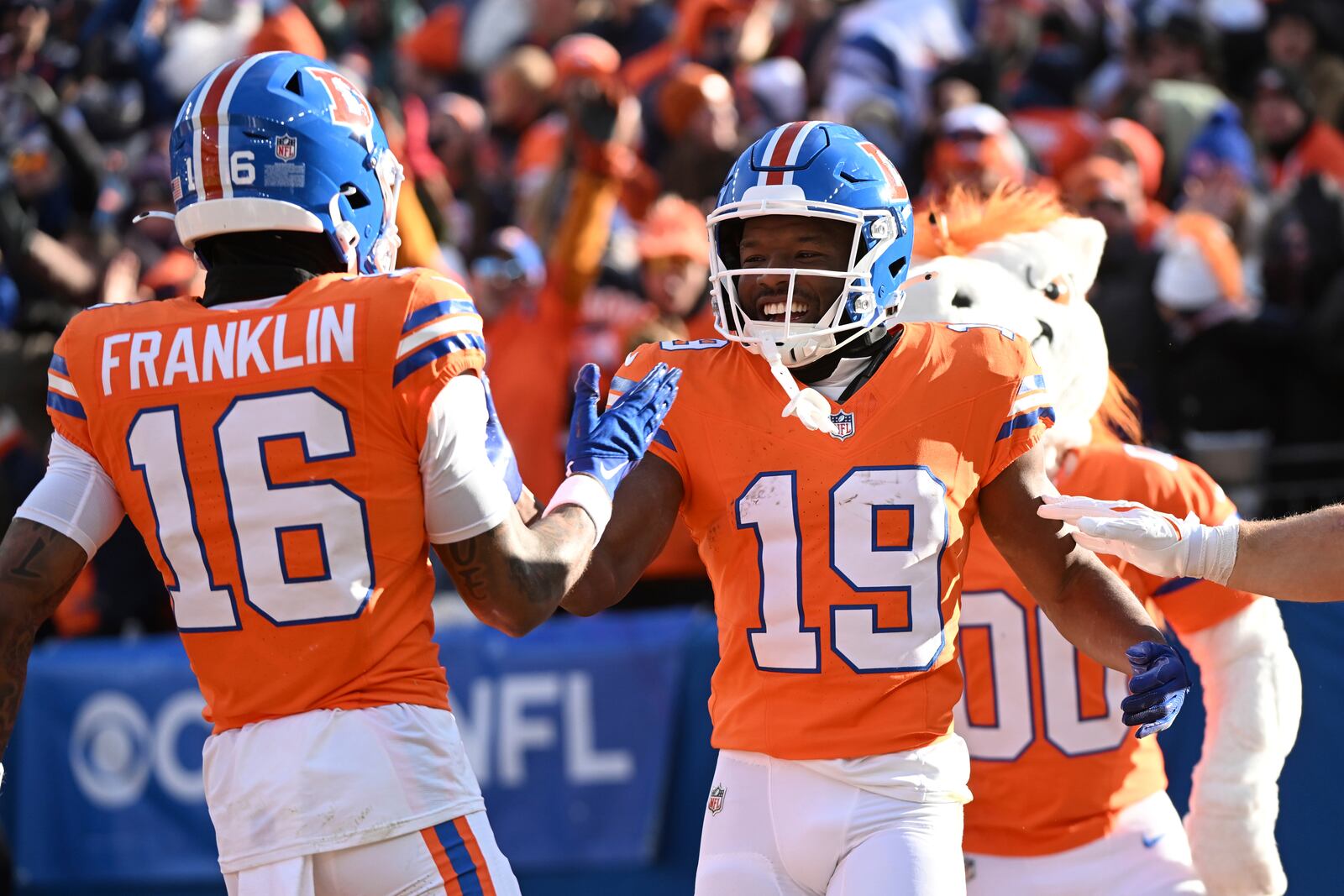 Denver Broncos wide receiver Marvin Mims Jr. (19) is congratulated by teammate Troy Franklin (16) after scoring during the first half of an NFL football game against the Kansas City Chiefs Sunday, Jan. 5, 2025, in Denver. (AP Photo/Geneva Heffernan)