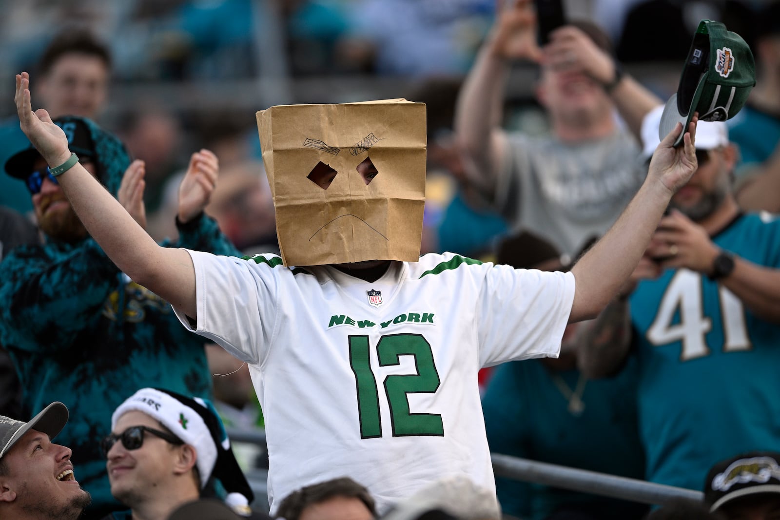 A New York Jets fan reacts to a missed field goal during the second half of an NFL football game against the Jacksonville Jaguars Sunday, Dec. 15, 2024, in Jacksonville, Fla. (AP Photo/Phelan M. Ebenhack)