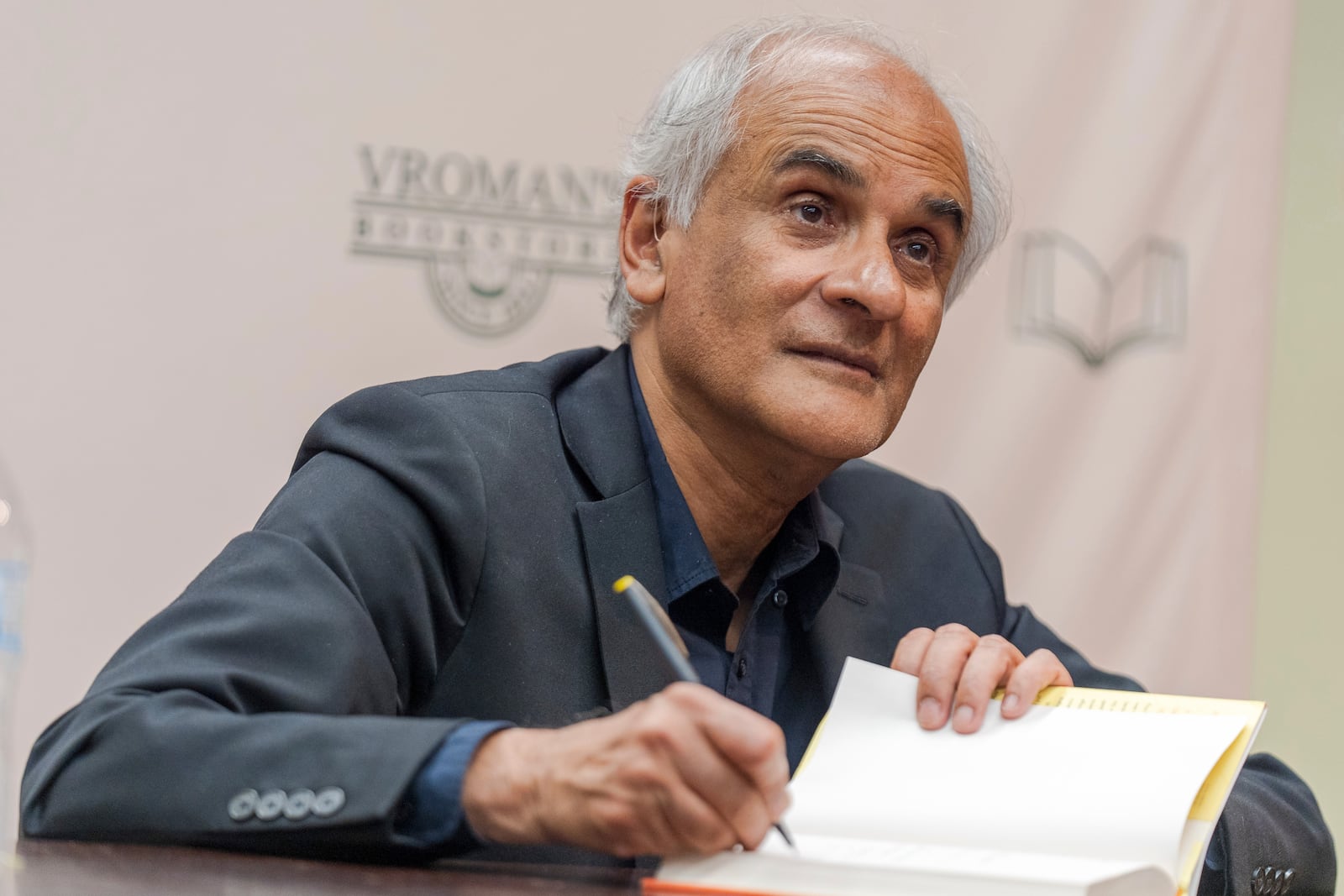 Pico Iyer, the bestselling author of "The Art of Stillness," presents his new book "Aflame: Learning from Silence" at Vroman's bookstore in Pasadena, Calif., on Tuesday, Jan. 28, 2025, in the wake of the devastating Eaton Fire that recently swept through parts of Pasadena and Altadena, forcing over 30,000 people to evacuate and burning thousands of structures. (AP Photo/Damian Dovarganes)