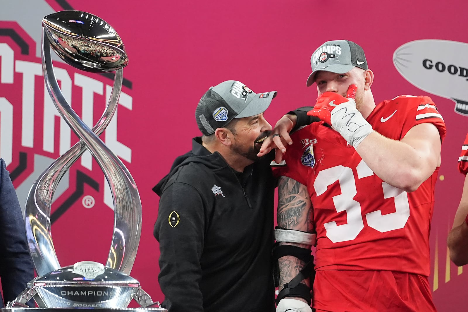 Ohio State head coach Ryan Day, left, celebrates with defensive end Jack Sawyer after the Cotton Bowl College Football Playoff semifinal game against Texas, Friday, Jan. 10, 2025, in Arlington, Texas. (AP Photo/Julio Cortez)