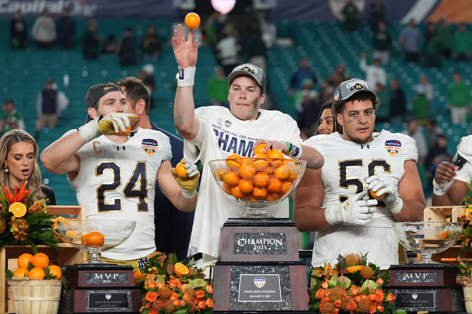 Notre Dame quarterback Riley Leonard (13) throws oranges to his teammates after winning the Orange Bowl College Football Playoff semifinal game against Penn State, Thursday, Jan. 9, 2025, in Miami Gardens, Fla. (AP Photo/Lynne Sladky)