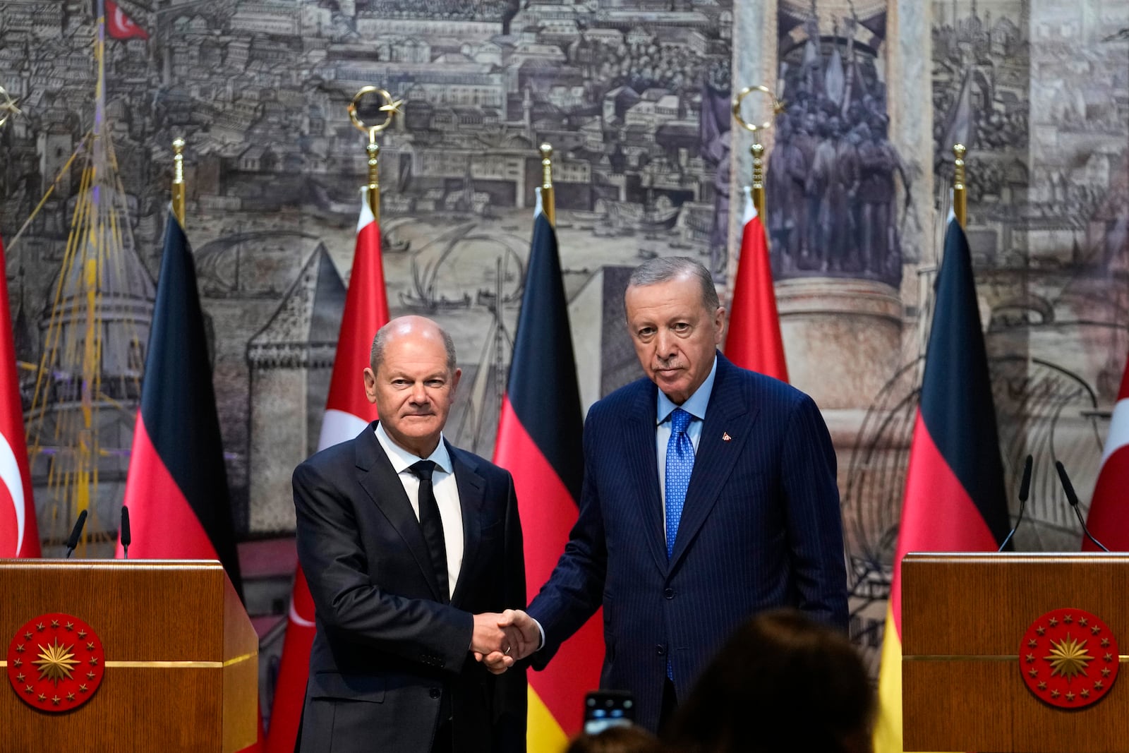 Turkey's President Recep Tayyip Erdogan, right, shakes hands with Germany's Chancellor Olaf Scholz, following a press conference in Istanbul, Turkey, Saturday, Oct. 19, 2024. (AP Photo/Khalil Hamra)