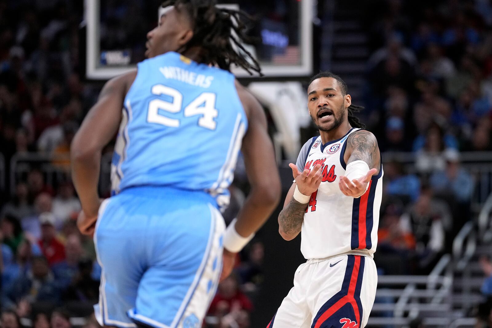 Mississippi guard Dre Davis, right, reacts after scoring a 3-point basket against North Carolina during the first half in the first round of the NCAA college basketball tournament, Friday, March 21, 2025, in Milwaukee, Wis. (AP Photo/Kayla Wolf)