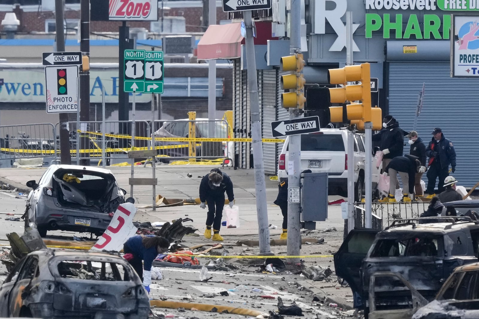 Investigators work the scene after a small plane crashed in Philadelphia, Saturday, Feb. 1, 2025. (AP Photo/Matt Rourke)