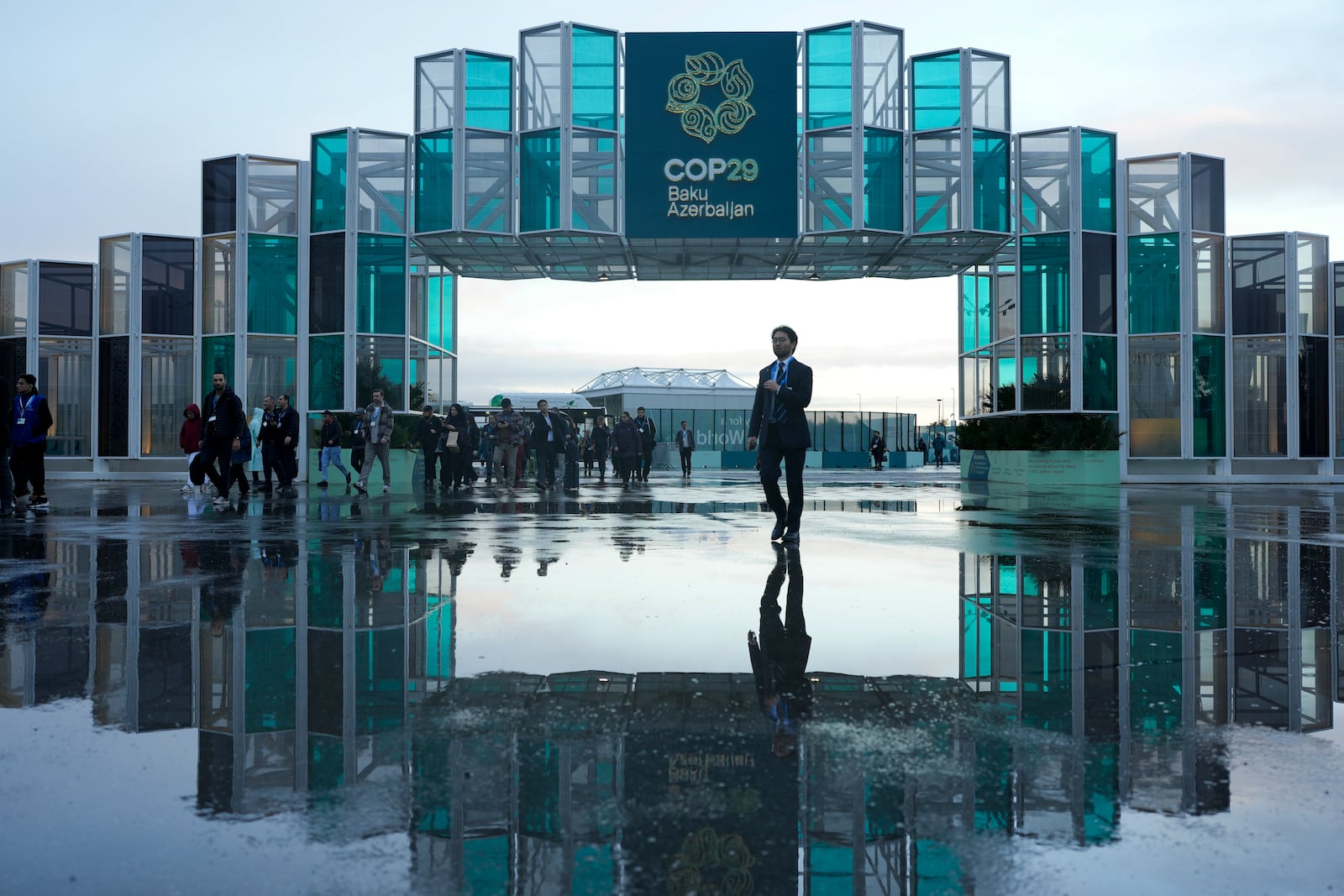 Attendees arrive for the day at the COP29 U.N. Climate Summit, Thursday, Nov. 14, 2024, in Baku, Azerbaijan. (AP Photo/Rafiq Maqbool)