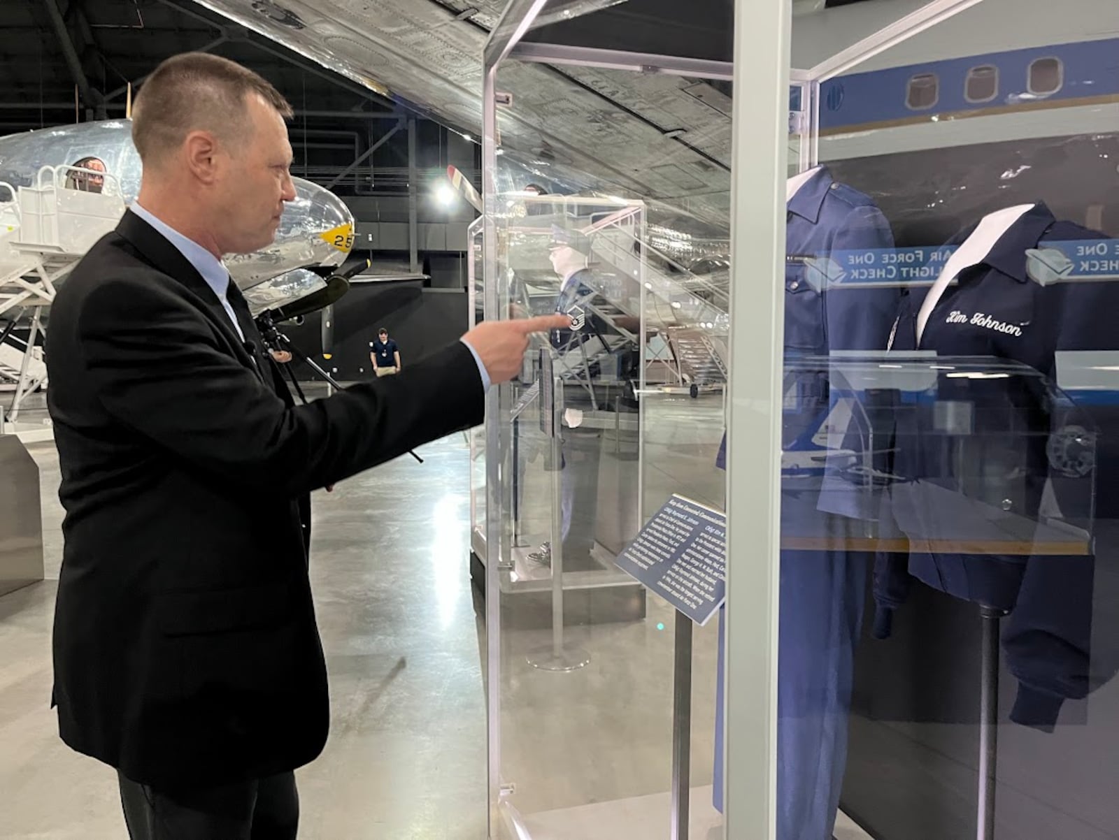 Doug Lantry, historian at the National Museum of the U.S. Air Force, points to a jacket used by retired Air Force Chief Master Sgt. Kim Johnson, who served presidents on Air Force One. THOMAS GNAU/STAFF