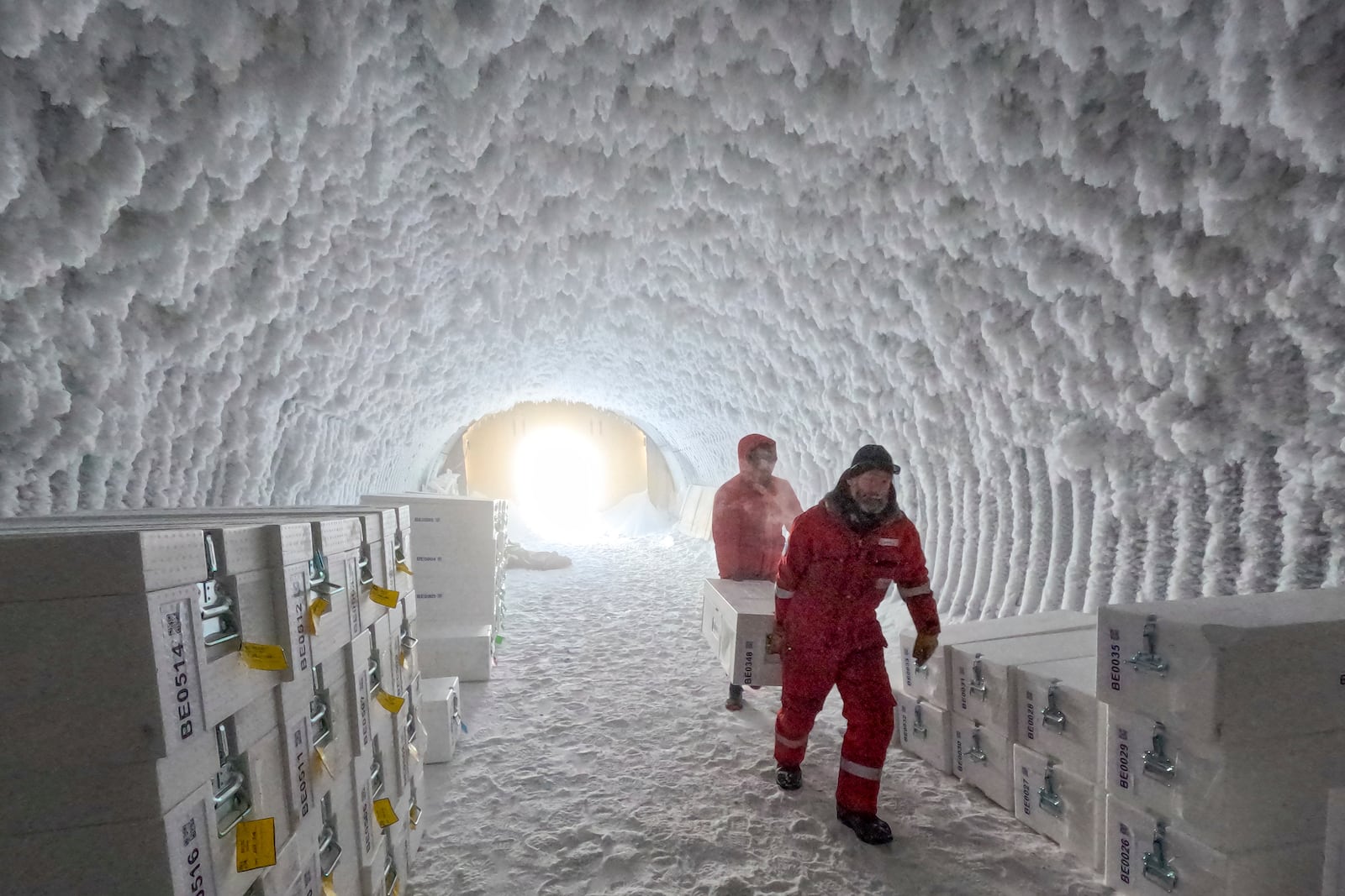 People walk through an ice core storage cave at Little Dome C field base on Tuesday, Jan. 7, 2025, in in eastern Antarctica. (PNRA/IPEV Beyond Epica via AP)