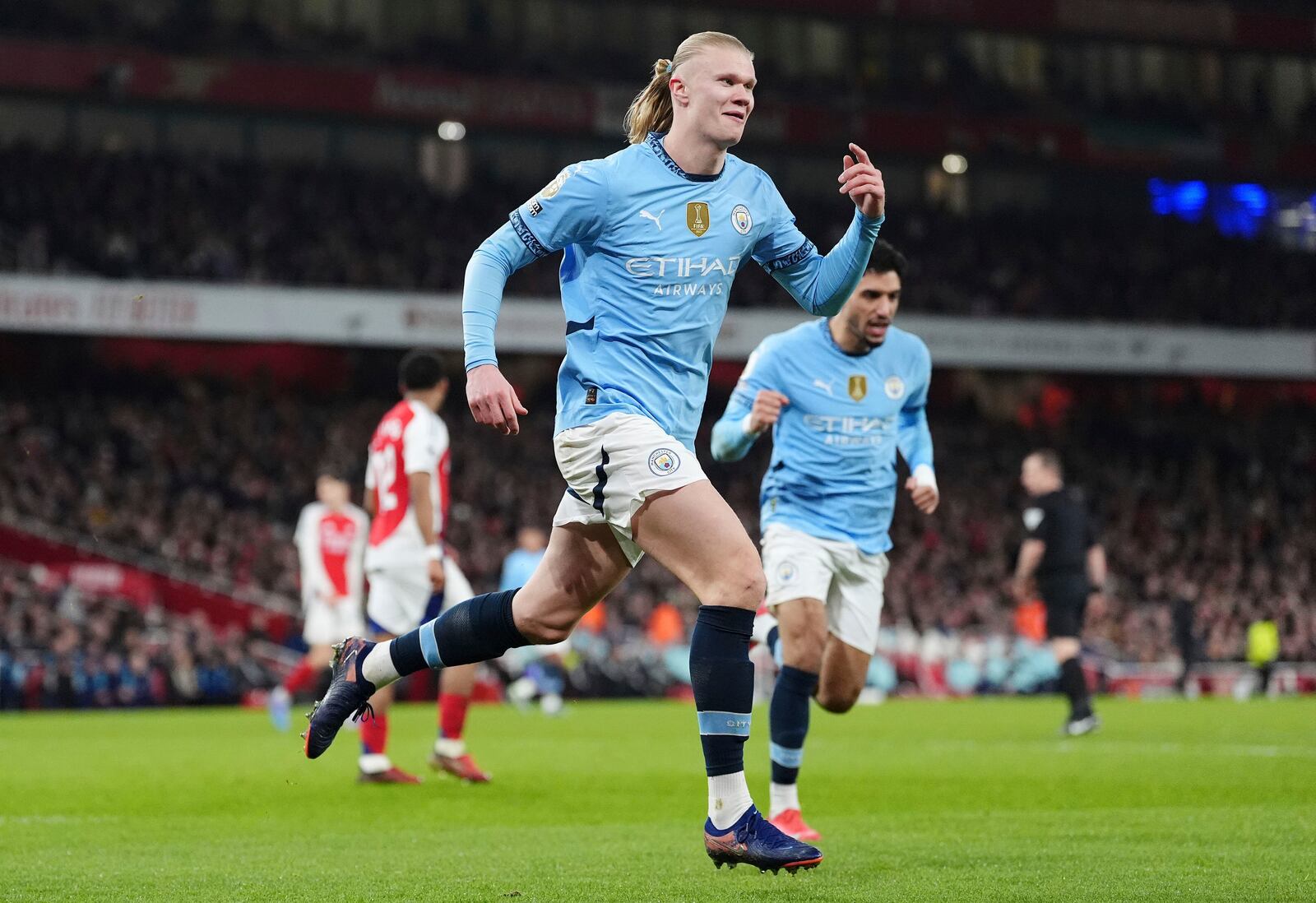 Manchester City's Erling Haaland celebrates scoring his side's first goal during the English Premier League soccer match between Arsenal and Manchester City at the Emirates stadium in London, Sunday, Feb. 2, 2025. (Adam Davy/PA via AP)