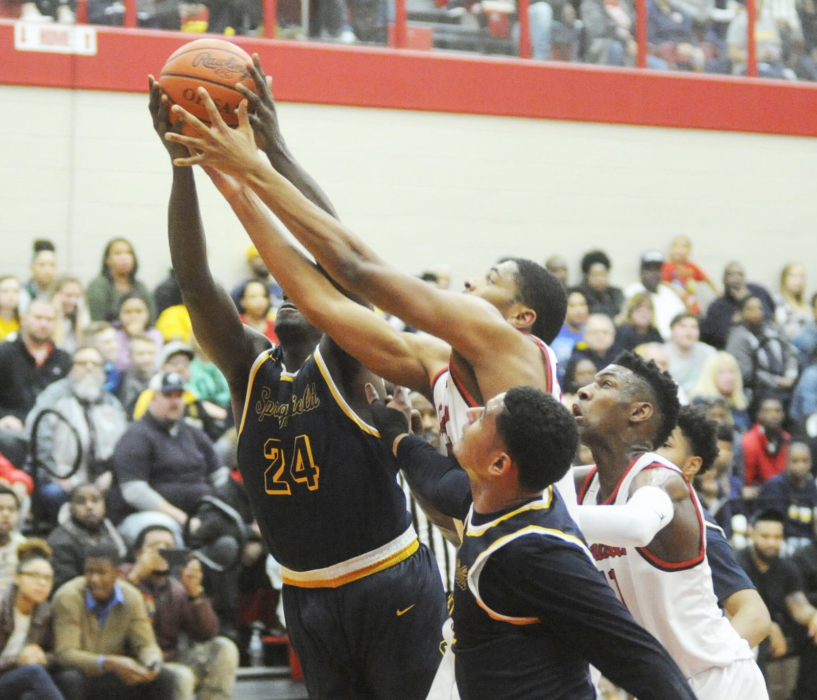 Springfield’s Derrick Robinson-Verse (24) and Leonard Taylor (front) battle Trotwood’s Justin Stephens (middle) and Carl Blanton for a rebound. Trotwood-Madison defeated visiting Springfield 79-72 in boys high school basketball on Friday, Feb. 16, 2018. MARC PENDLETON / STAFF