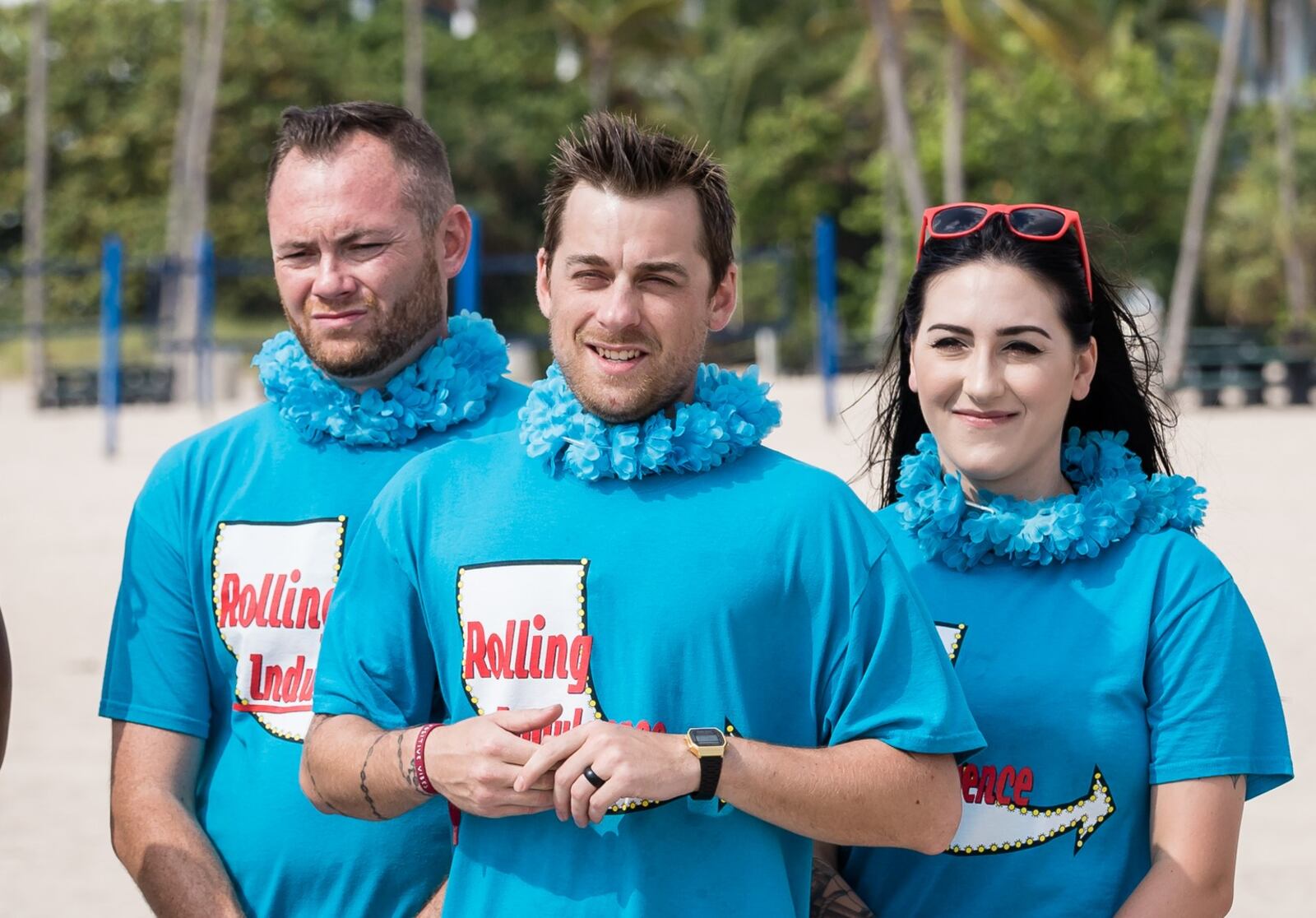 The Rolling Indulgence team, consisting of three employees of Carvers Steaks &  Chops, listens to the challenge rules on The Great Food Truck Race, Season 10, on the Food Network.