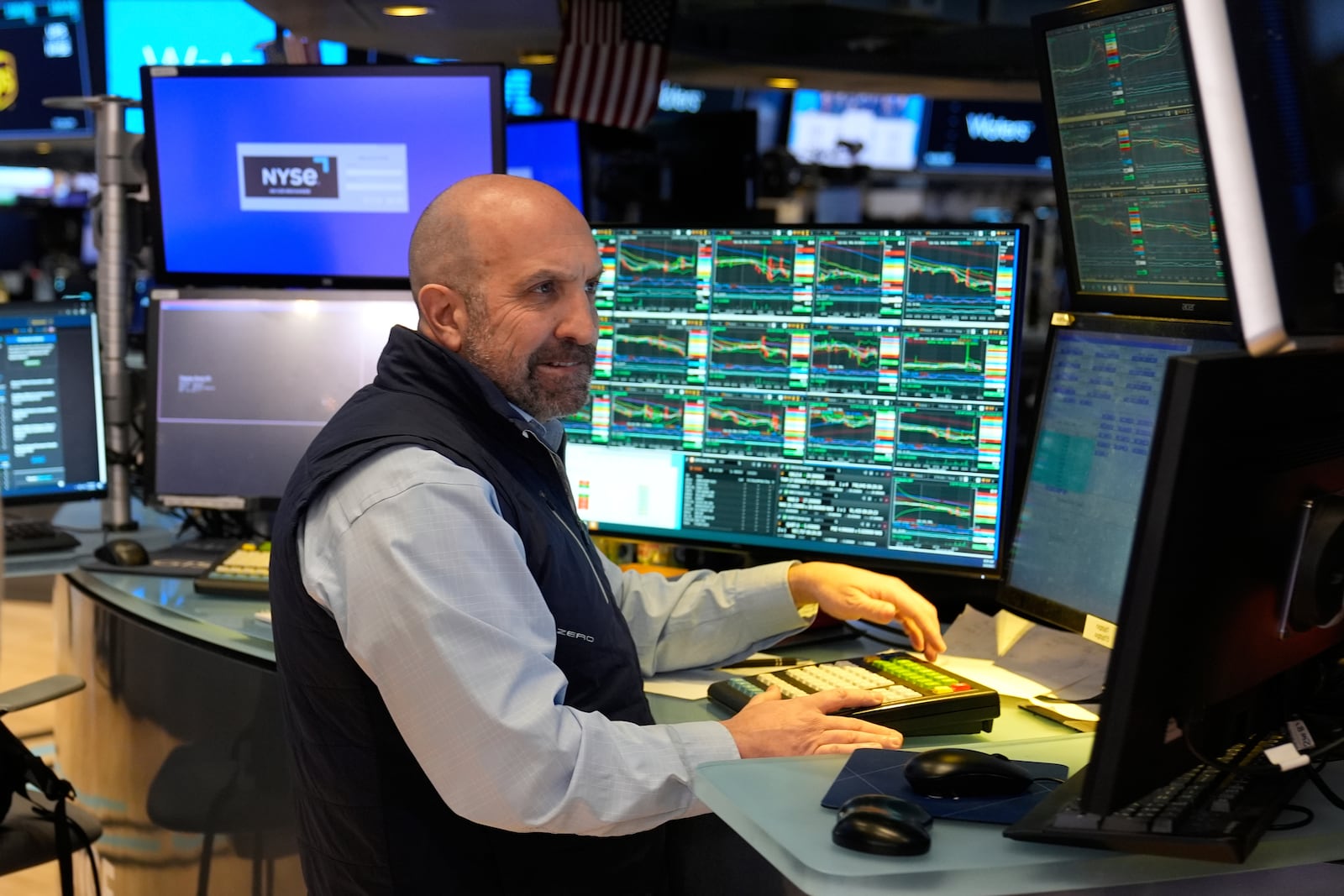 People work on the floor at the New York Stock Exchange in New York, Tuesday, March 4, 2025. (AP Photo/Seth Wenig)