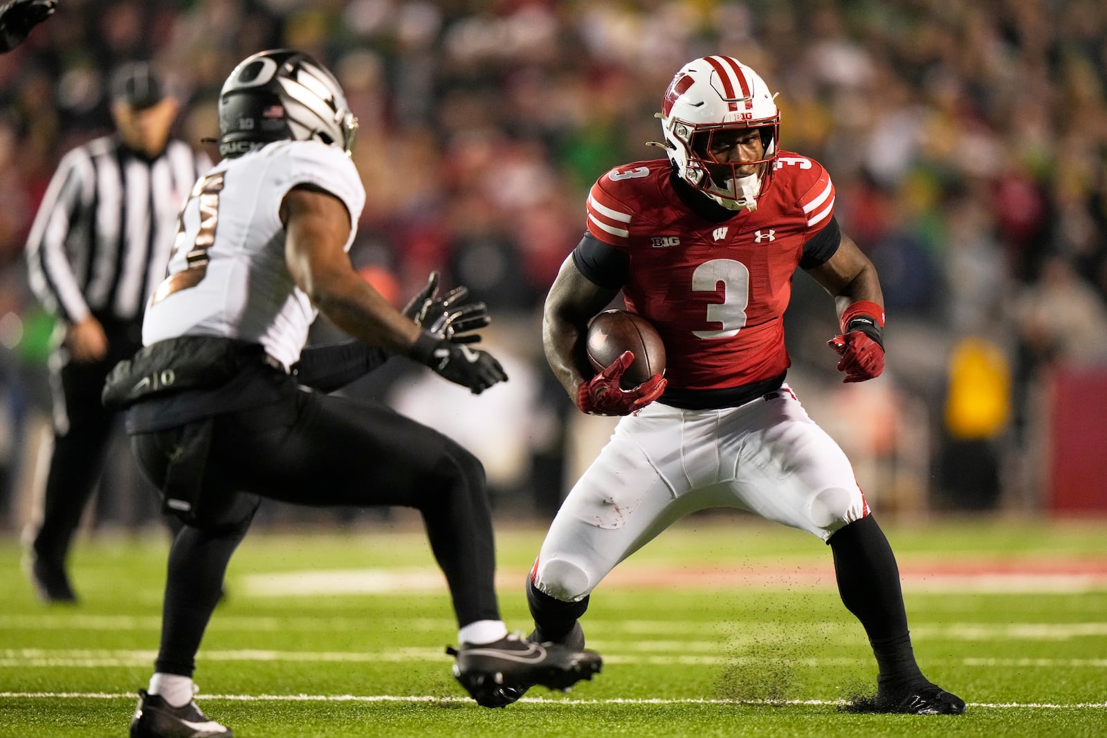 Wisconsin's Tawee Walker (3) tries to get past Oregon's Tysheem Johnson (0) during the first half of an NCAA college football game Saturday, Nov. 16, 2024, in Madison, Wis. (AP Photo/Morry Gash)