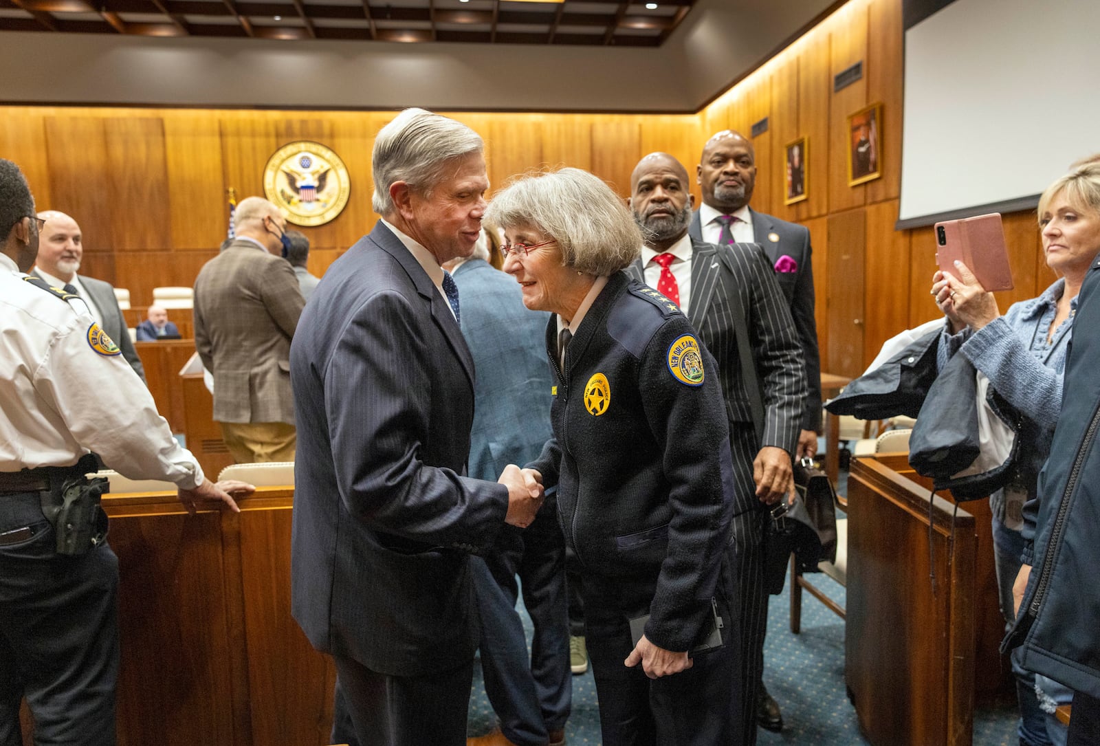 New Orleans Police Superintendent Anne Kirkpatrick, center, shakes hands with Rafael Goyeneche, left, president of the Metropolitan Crime Commission, on her way out of Federal Court, Tuesday, Jan. 14, 2025, in New Orleans, after a judge ruled the New Orleans Police Department can begin the process of ending longstanding federal oversight. (Chris Granger/The Times-Picayune/The New Orleans Advocate via AP)