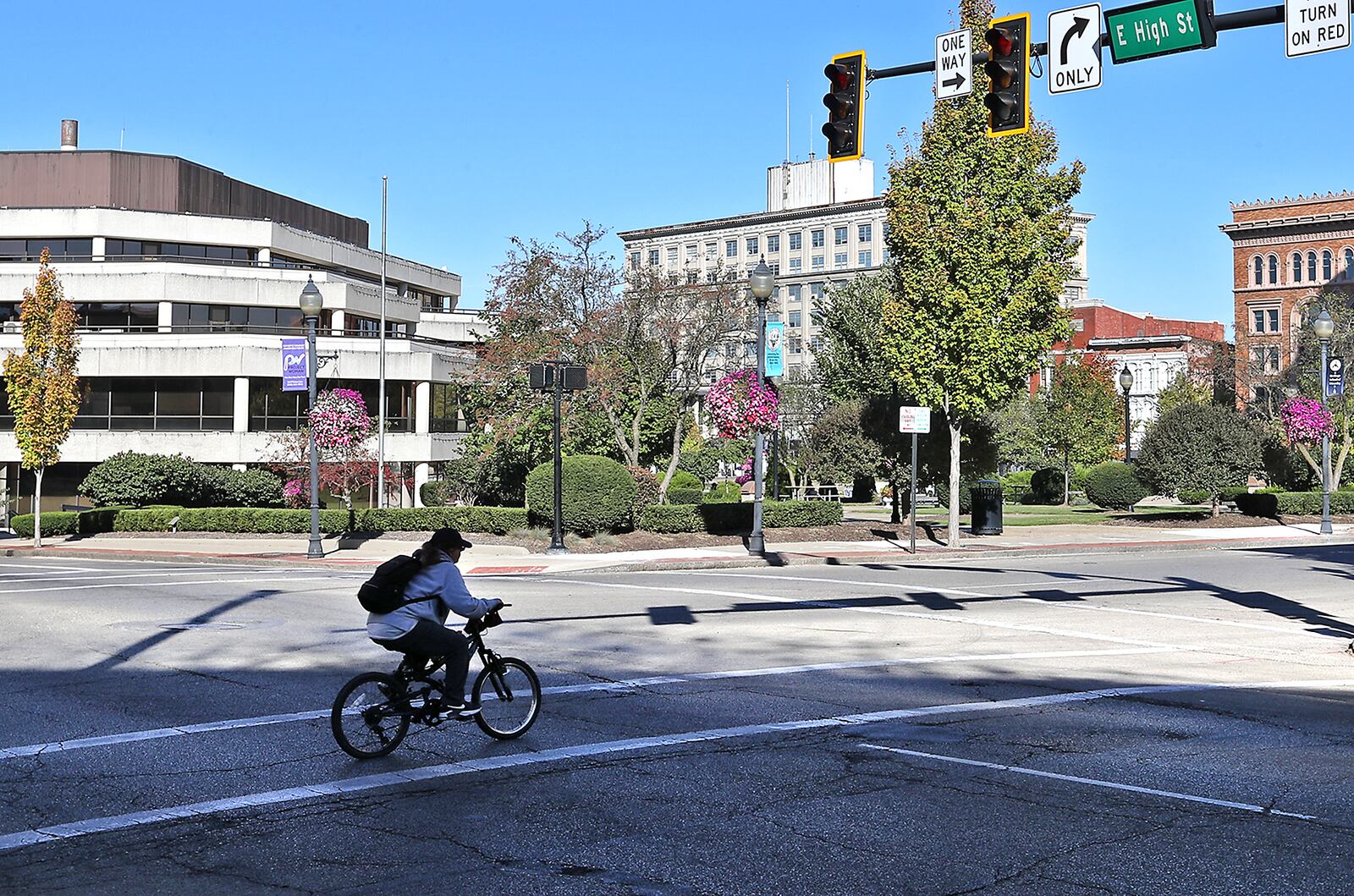 A bicyclist crosses High Street while traveling along South Limestone Street in downtown Springfield Wednesday, Oct. 5, 2022. BILL LACKEY/STAFF